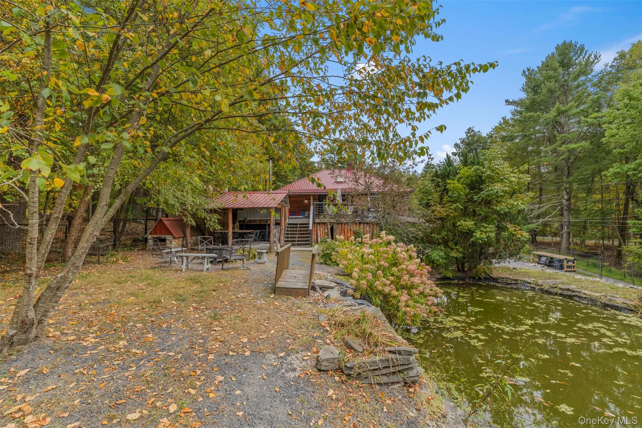 Back of property featuring stairway and a small pond Back of property featuring stairway and a small pond