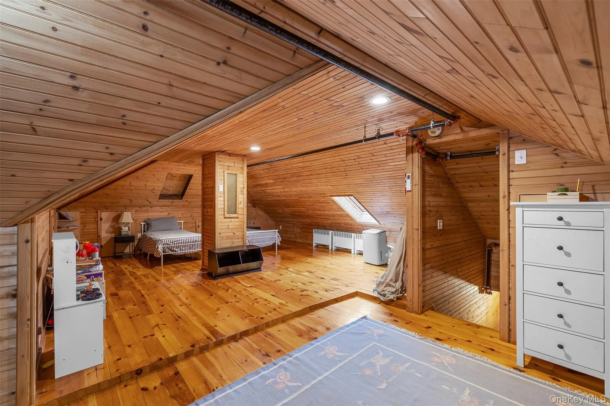 Unfurnished bedroom featuring hardwood / wood-style flooring, wooden walls, wood ceiling, and lofted ceiling Unfurnished bedroom featuring hardwood / wood-style flooring, wooden walls, wood ceiling, and lofted ceiling