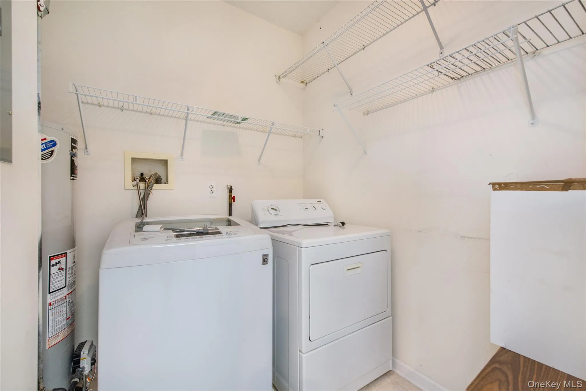 Dedicated laundry area featuring white walls and wire shelving Dedicated laundry area featuring white walls and wire shelving