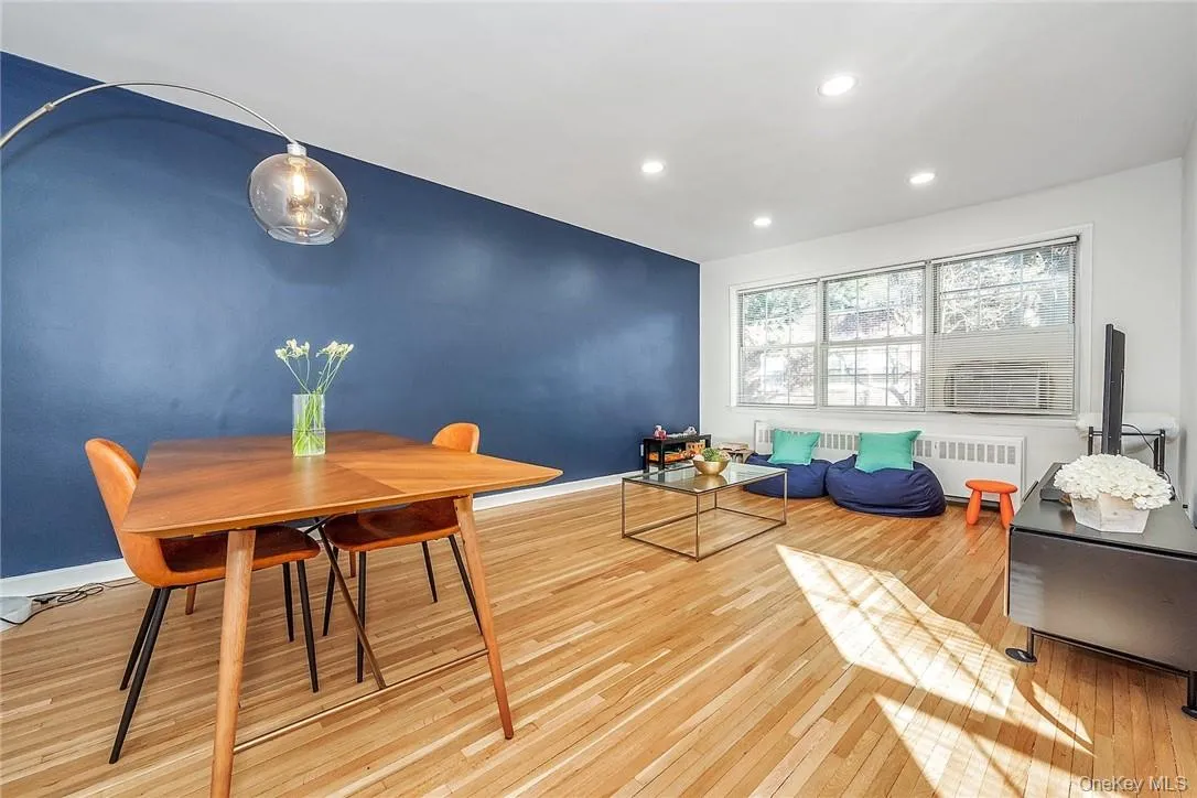 Light and bright living and dining area, well-maintained hardwood floors throughout unit Light and bright living and dining area, well-maintained hardwood floors throughout unit