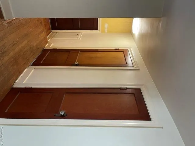 Second floor. First door is a linen closet. Second door is a full bathroom. Third smaller door leads to an attic over the addition. Second floor. First door is a linen closet. Second door is a full bathroom. Third smaller door leads to an attic over the addition.