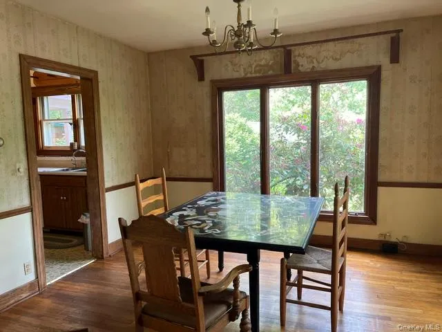 The dining room connects to both the kitchen and the living room with wood floors The dining room connects to both the kitchen and the living room with wood floors