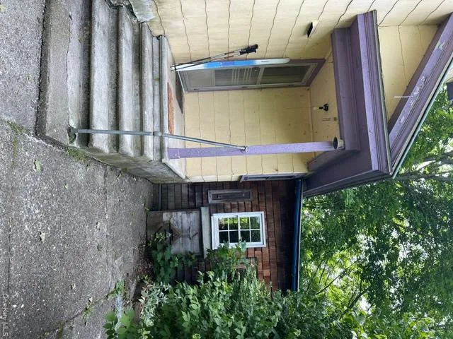 Entrance into the kitchen from with driveway with anoth wood bin to the side Entrance into the kitchen from with driveway with anoth wood bin to the side