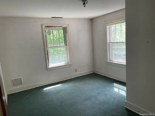 There are wood floors beneath the carpeting. The access to the walk-up attic is in this bedroom There are wood floors beneath the carpeting. The access to the walk-up attic is in this bedroom