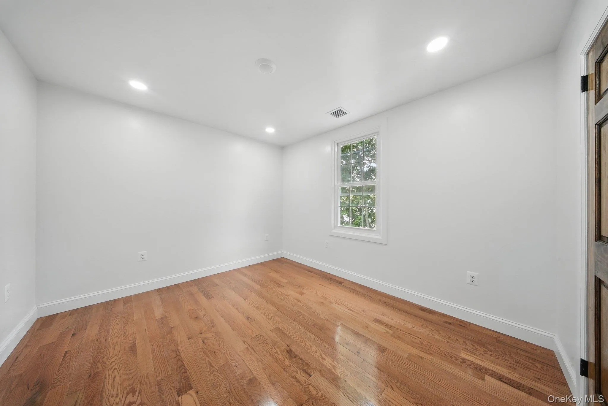 Unfurnished bedroom, light wood floors, and recessed lighting Unfurnished bedroom, light wood floors, and recessed lighting