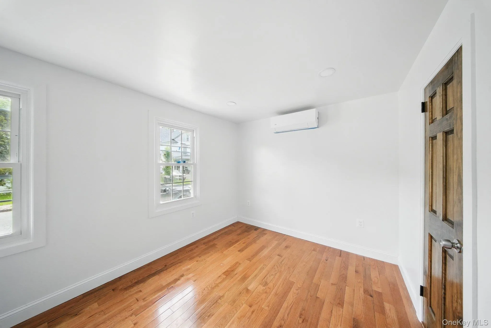 Bedroom with healthy amount of natural light, light wood flooring, and recessed lighting Bedroom with healthy amount of natural light, light wood flooring, and recessed lighting