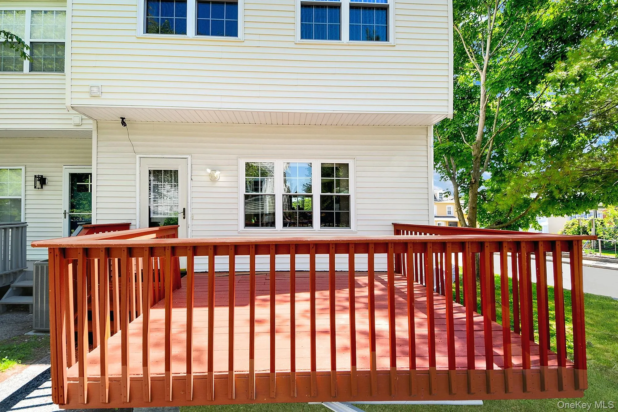 Large wooden deck off the kitchen where you can grill and dine al fresco Large wooden deck off the kitchen where you can grill and dine al fresco