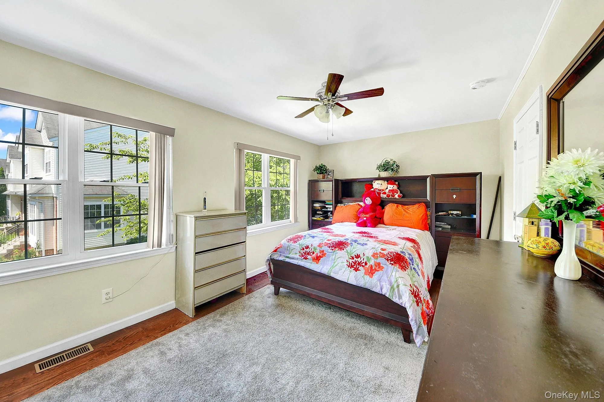 Primary bedroom with large windows, large closets, hardwood floors and an en-suite bathroom Primary bedroom with large windows, large closets, hardwood floors and an en-suite bathroom