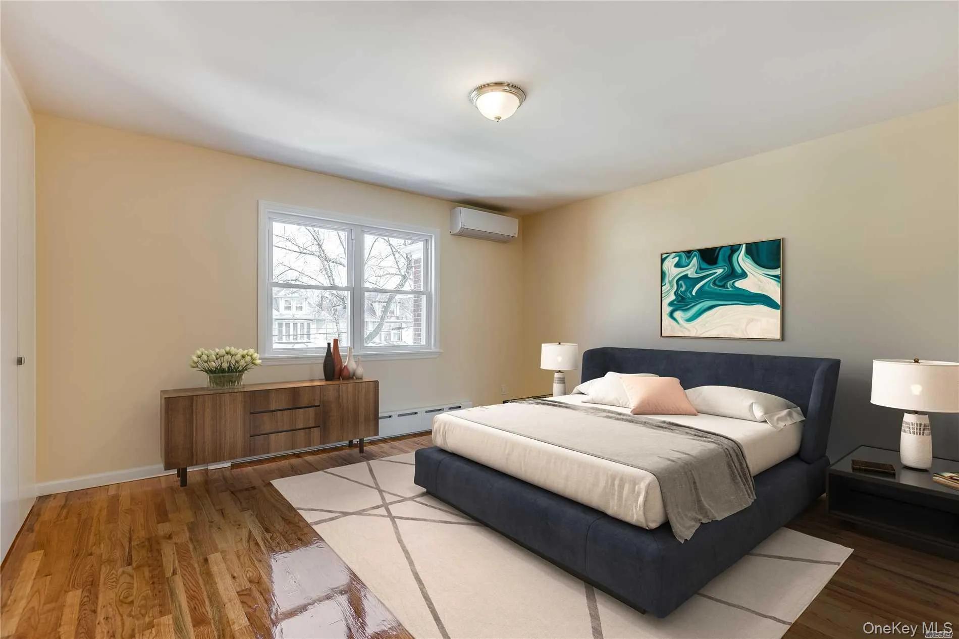 Room featuring wood-finish flooring, a double-paned window, and a built-in air conditioning unit Room featuring wood-finish flooring, a double-paned window, and a built-in air conditioning unit