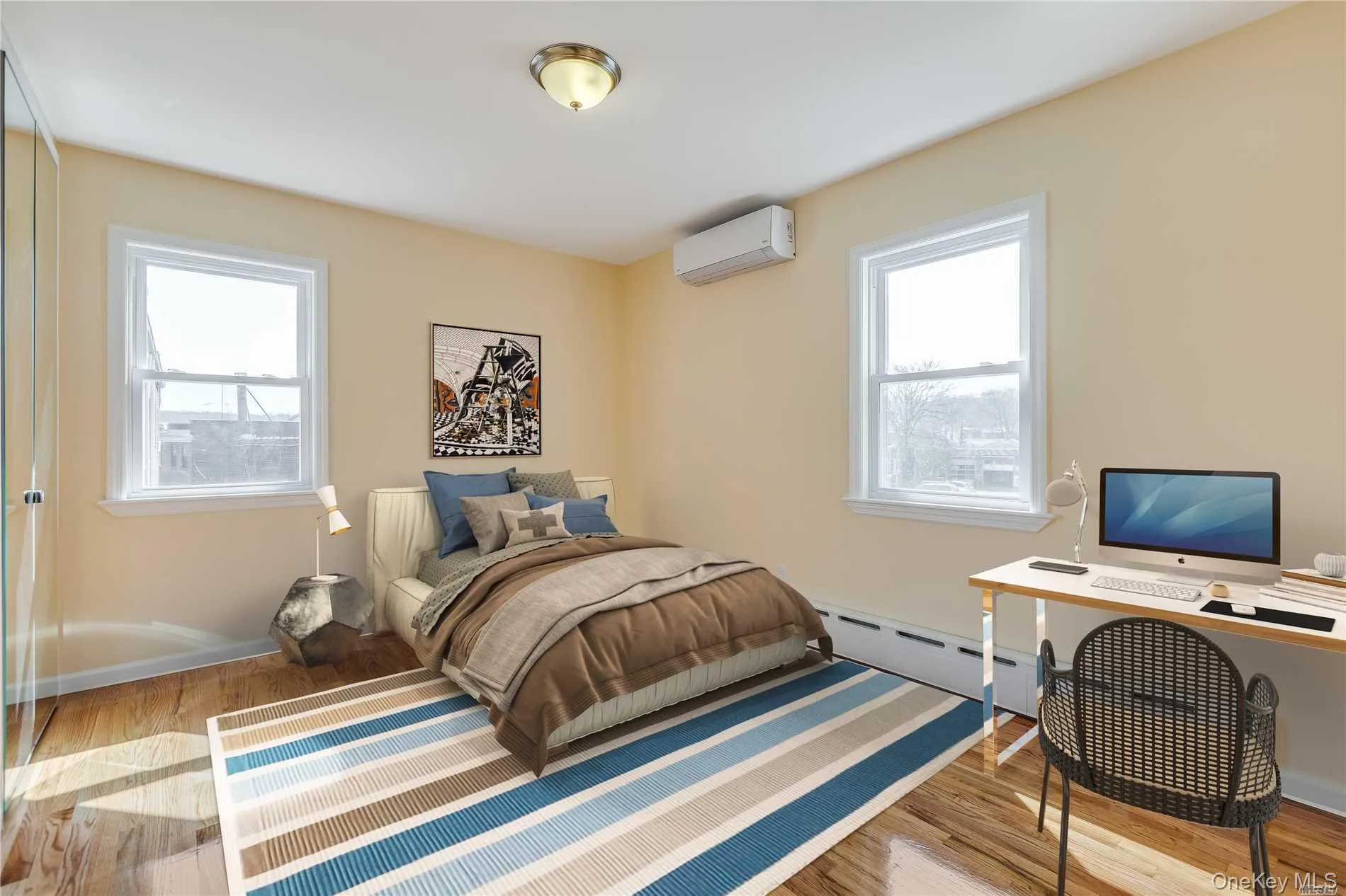 Bedroom featuring wood-finish flooring, two large windows, a built-in baseboard heating unit, and a wall-mounted mini-split HVAC system Bedroom featuring wood-finish flooring, two large windows, a built-in baseboard heating unit, and a wall-mounted mini-split HVAC system