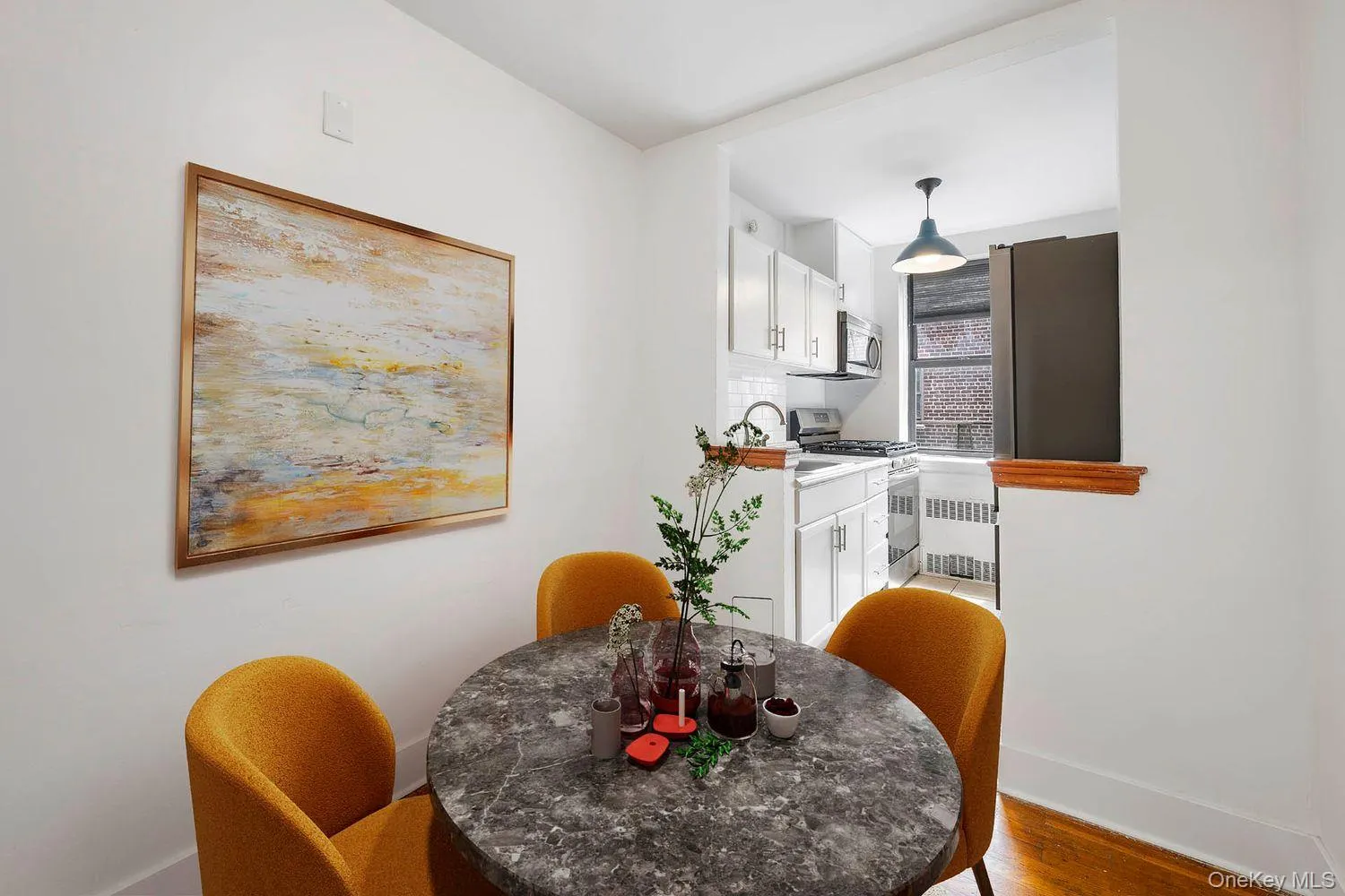 Dining room with radiator heating unit and wood finished floors Dining room with radiator heating unit and wood finished floors