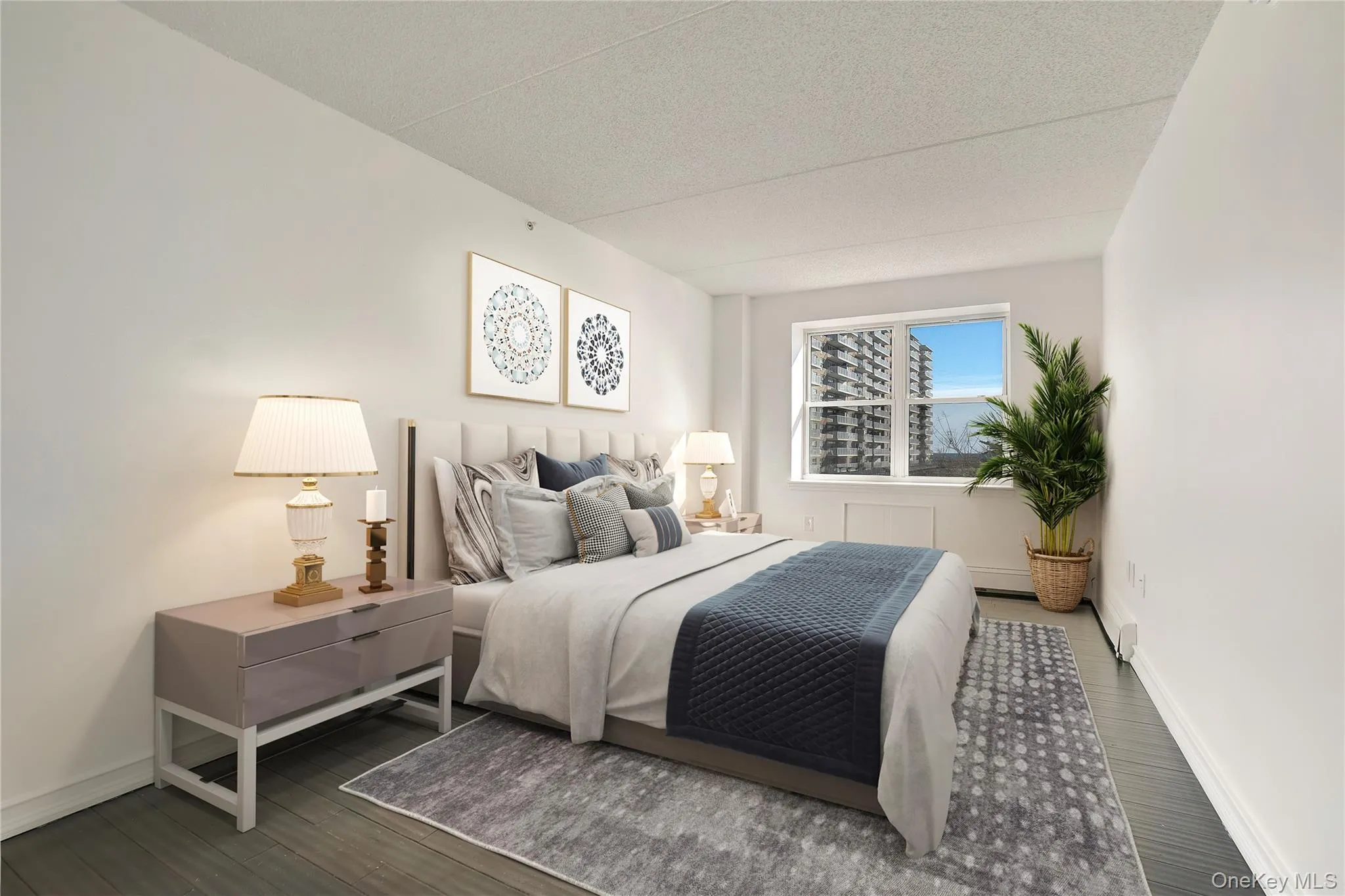 Bedroom featuring wood finished floors and a textured ceiling Bedroom featuring wood finished floors and a textured ceiling