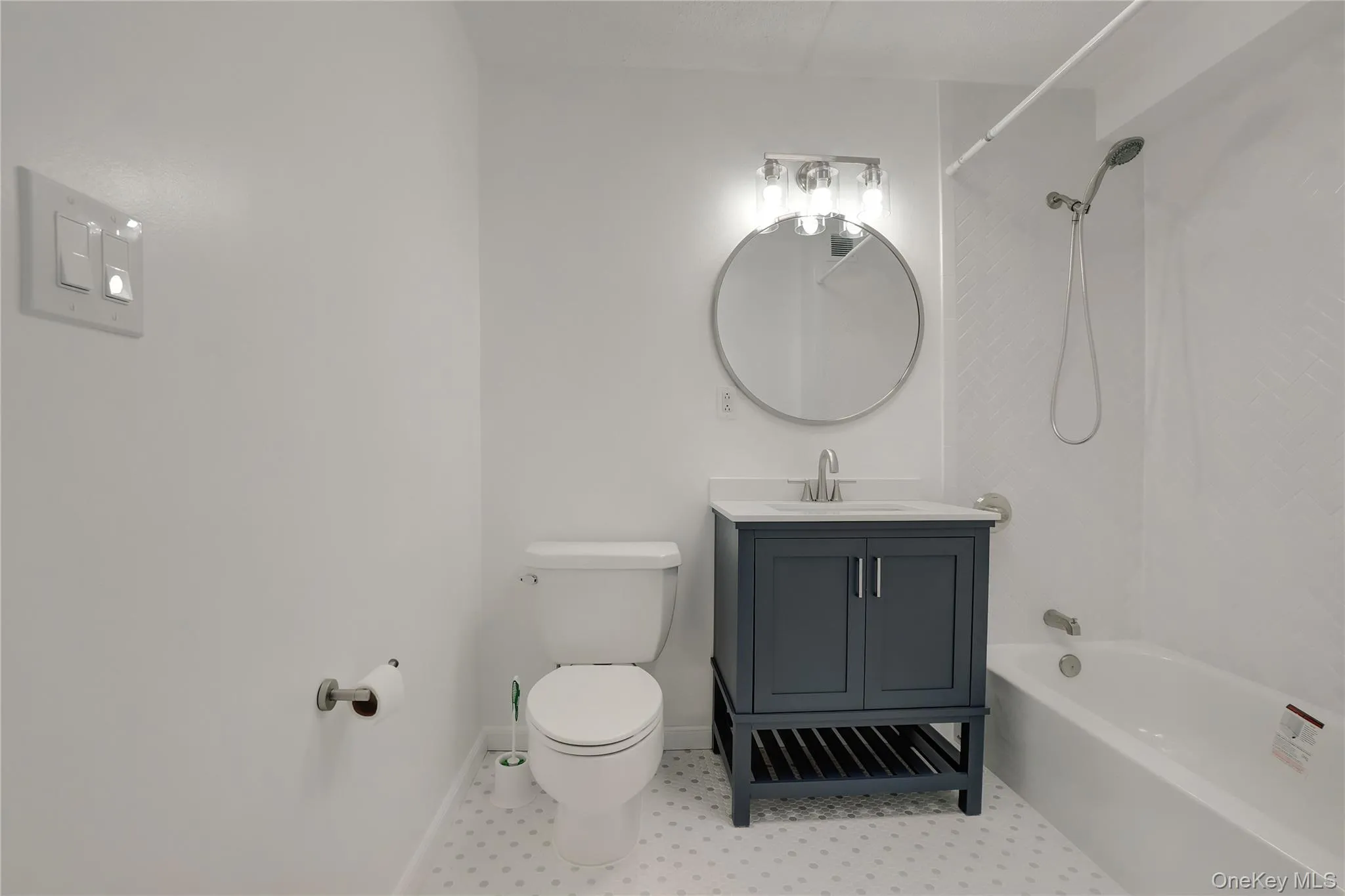 Full bathroom featuring washtub / shower combination and vanity Full bathroom featuring washtub / shower combination and vanity