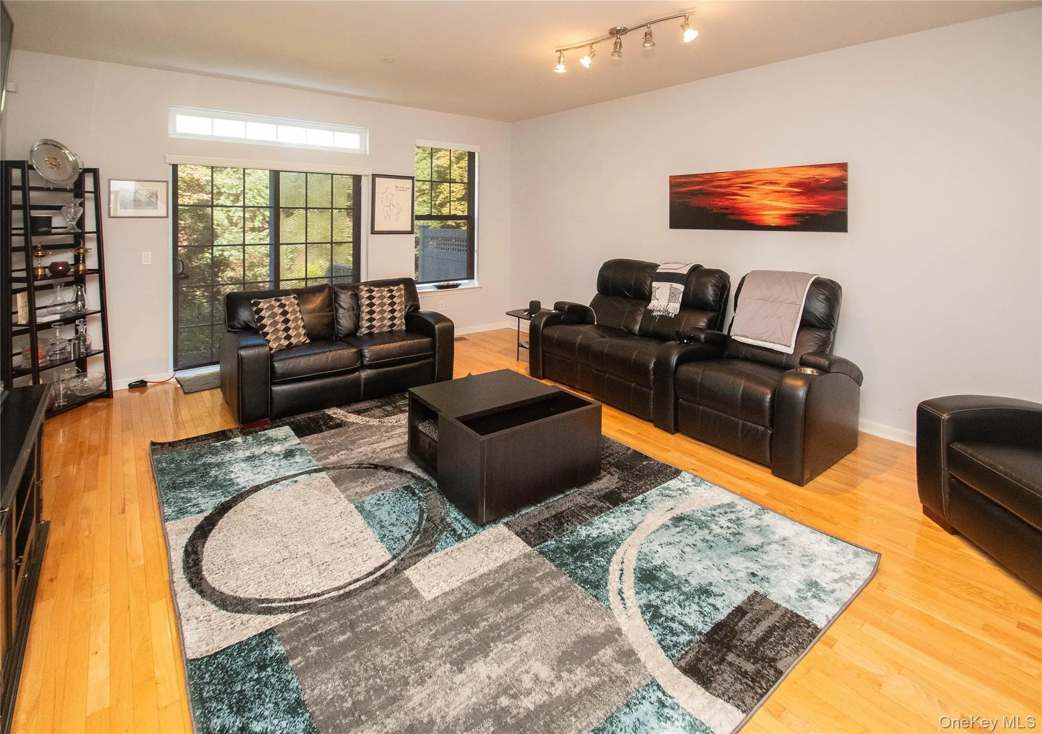 Living room featuring light wood-style floors and baseboards Living room featuring light wood-style floors and baseboards