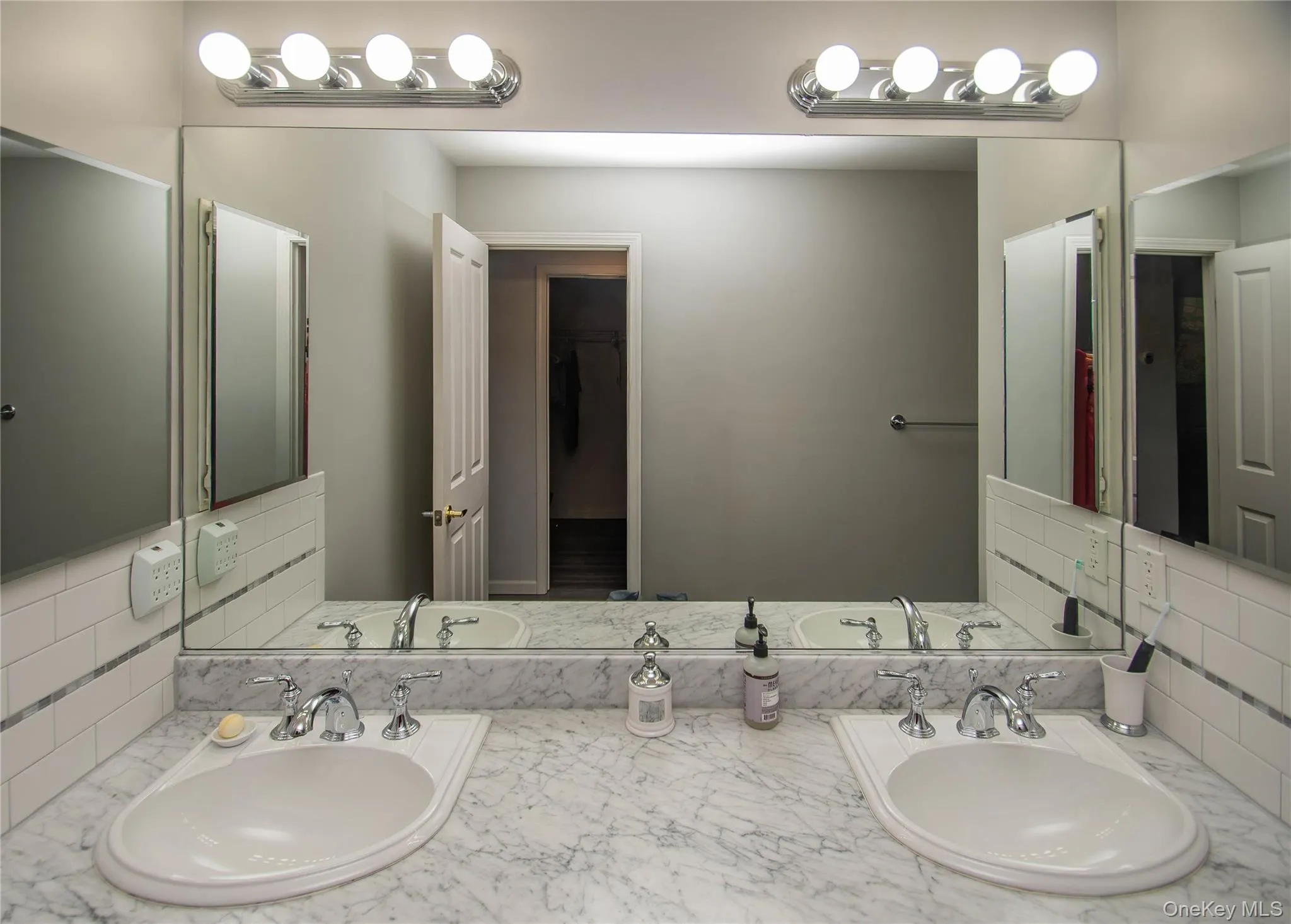 Bathroom with tasteful backsplash and double vanity Bathroom with tasteful backsplash and double vanity