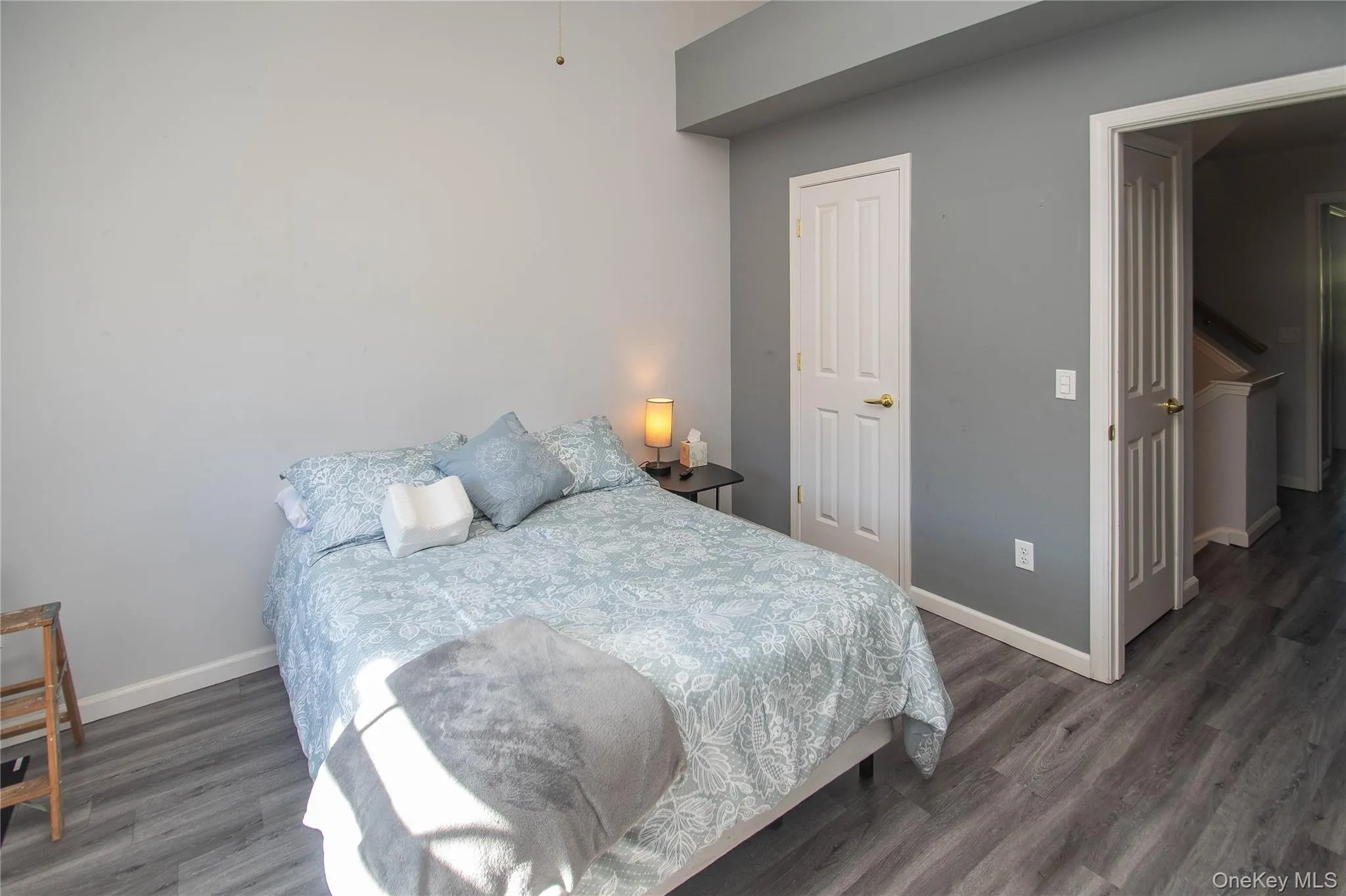 Bedroom featuring baseboards and dark wood finished floors Bedroom featuring baseboards and dark wood finished floors