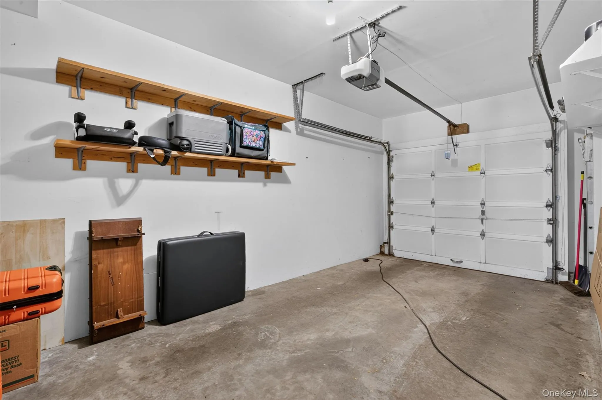 Attached Garage with additional storage area and shelves. Attached Garage with additional storage area and shelves.