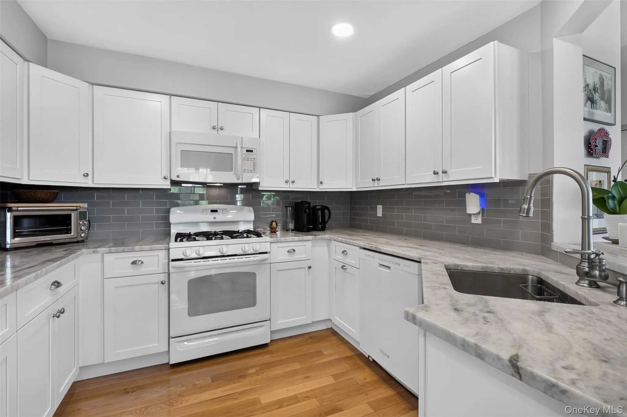 Beautifully Updated Lovely Kitchen - Highlights: Stone Counter, Quality Cabinetry, Wood Flooring, Gas Range. Beautifully Updated Lovely Kitchen - Highlights: Stone Counter, Quality Cabinetry, Wood Flooring, Gas Range.