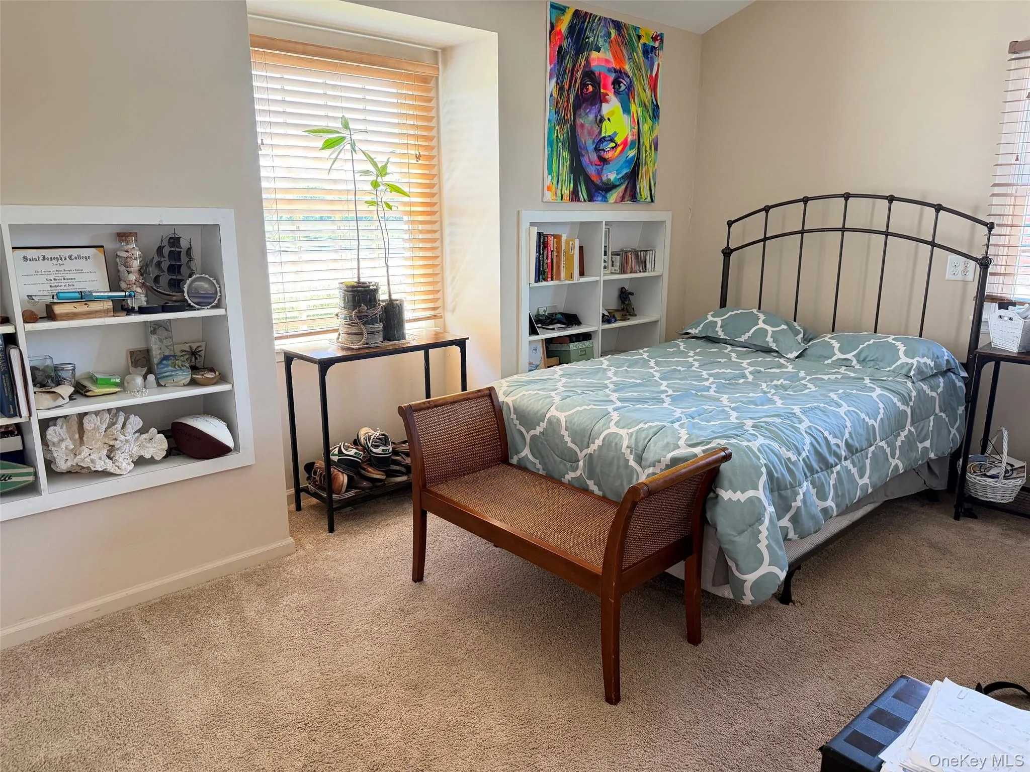 Room featuring a built-in shelving unit, a window with wood blinds, and wall-to-wall carpeting Room featuring a built-in shelving unit, a window with wood blinds, and wall-to-wall carpeting