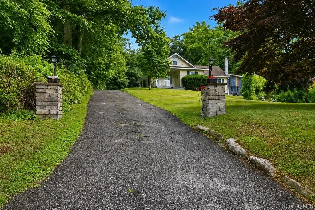 Nicely set back from the road between the stone pillars you'll find this adorable home! Nicely set back from the road between the stone pillars you'll find this adorable home!