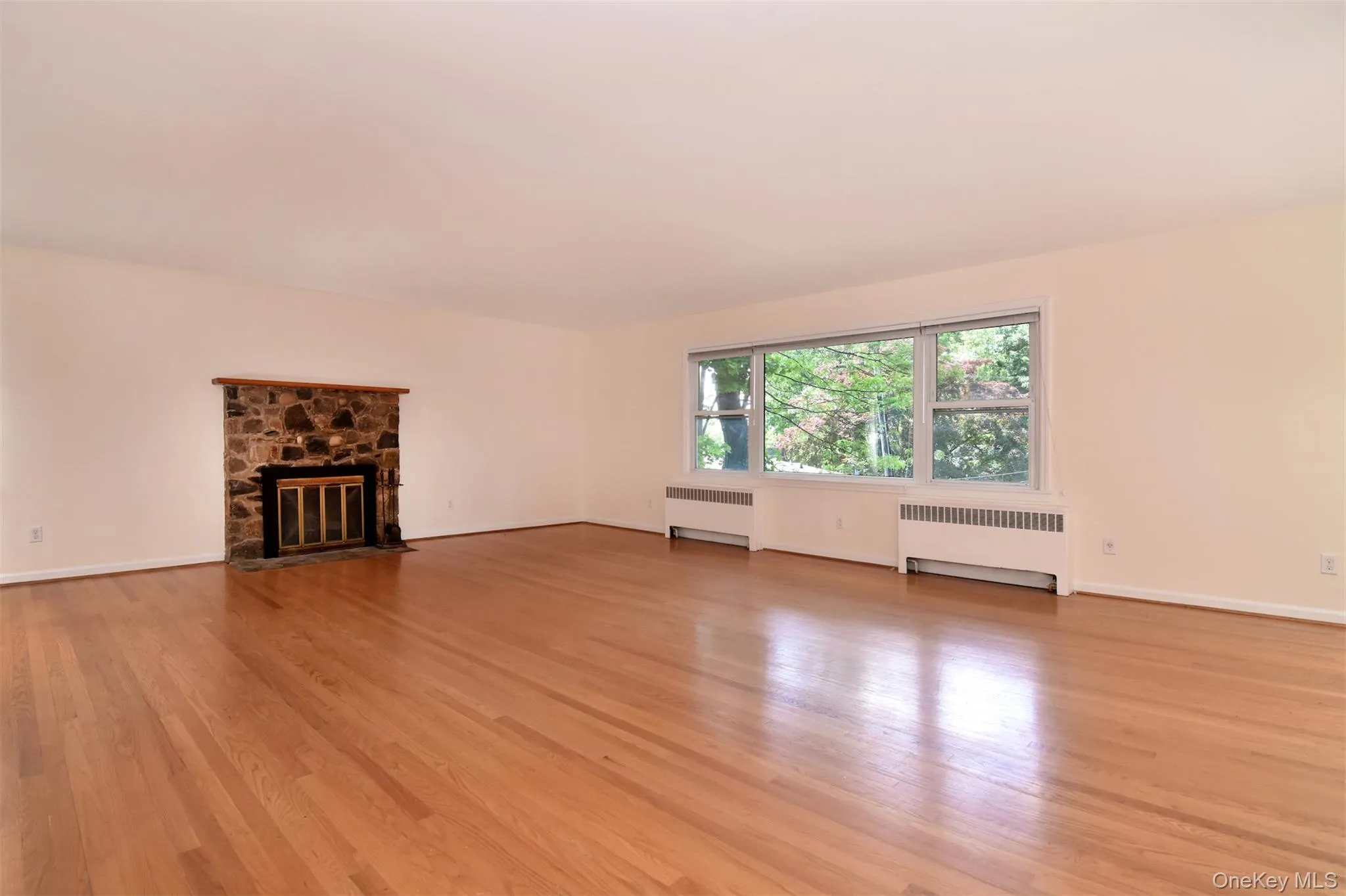 Stone fireplace. Oak hardwood floors. Stone fireplace. Oak hardwood floors.
