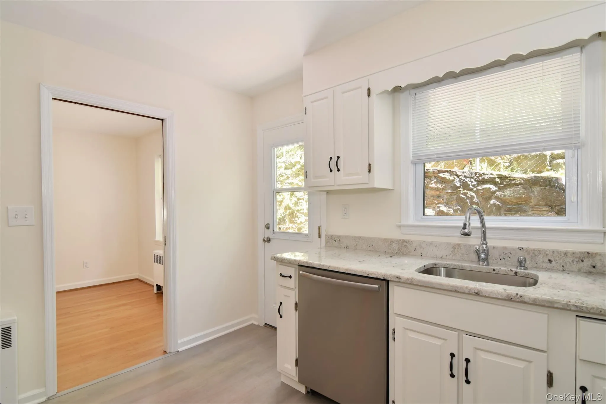 Kitchen with door out to patio for convenient summer grilling. Kitchen with door out to patio for convenient summer grilling.