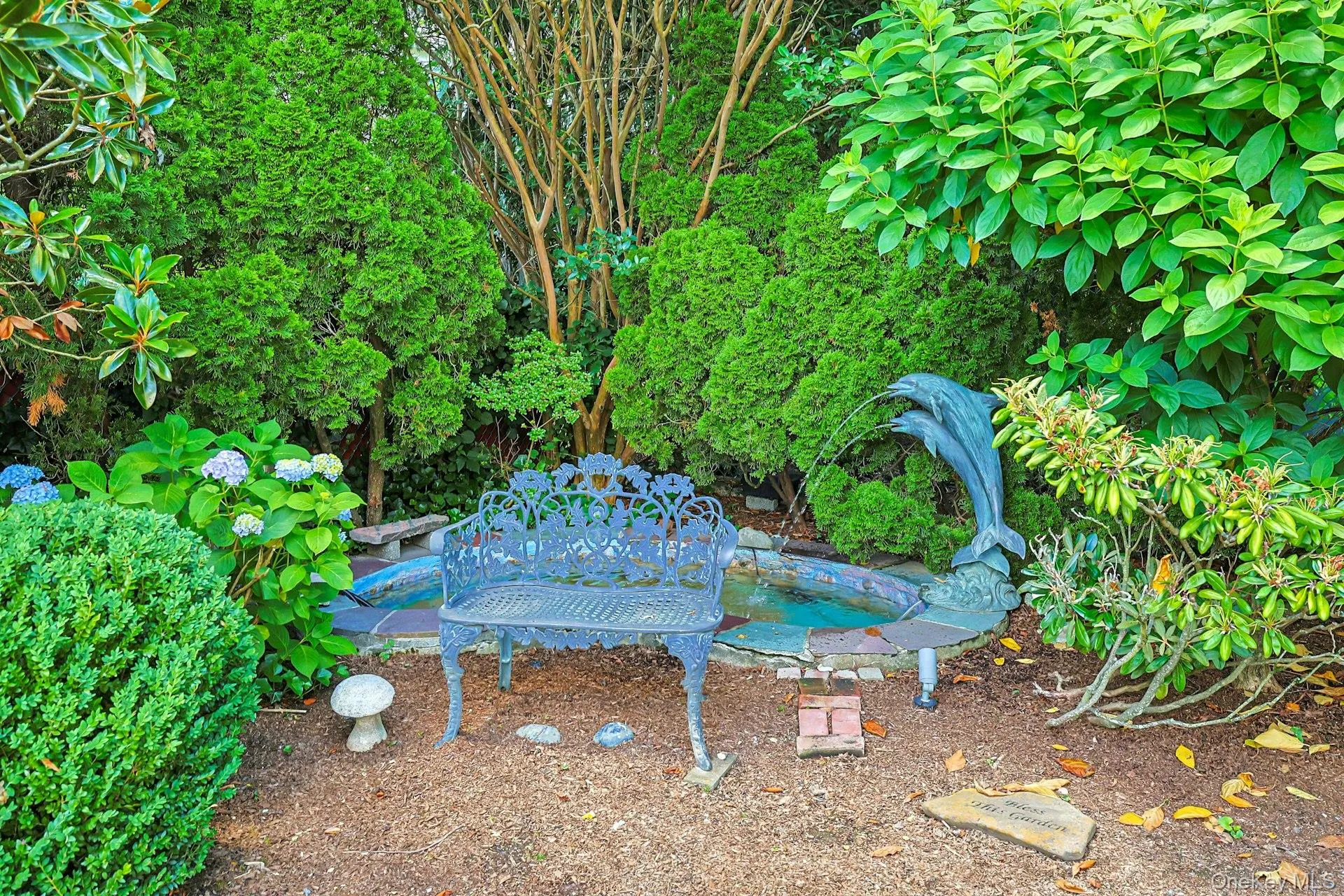 Tranquil ornamental pond with a dolphin fountain Tranquil ornamental pond with a dolphin fountain