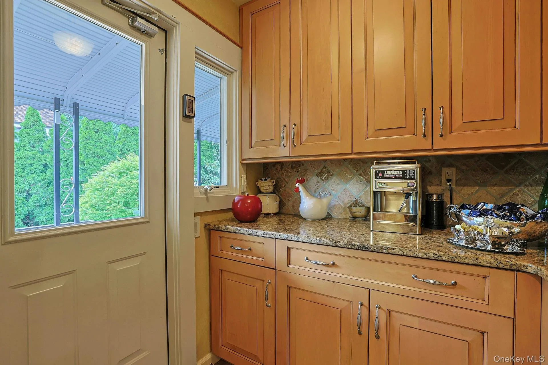 Butler's Pantry with ample storage, extra counter space, and access to terrace leading to lower patio Butler's Pantry with ample storage, extra counter space, and access to terrace leading to lower patio