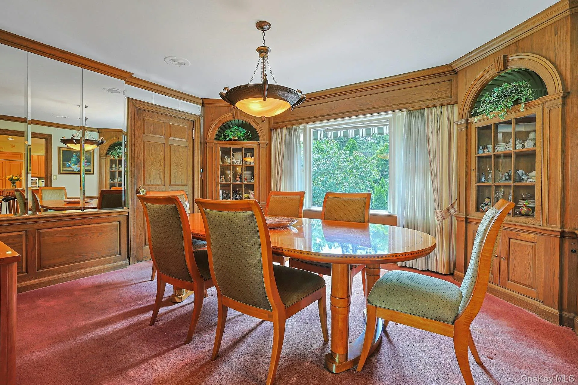 Dining room with custom built ins and door to upper patio Dining room with custom built ins and door to upper patio