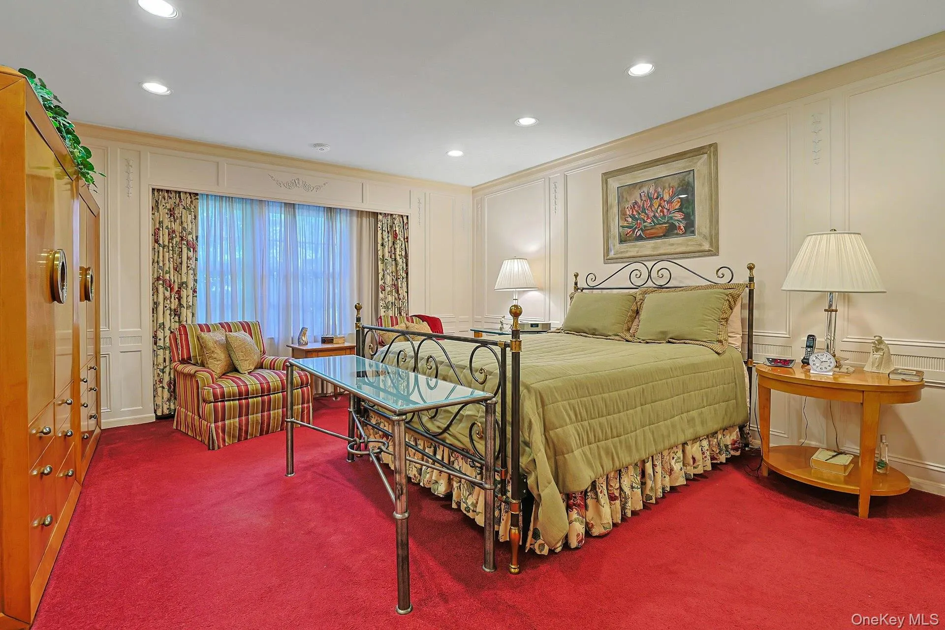 Primary suite with en suite bath and walk in closet with custom shelving Primary suite with en suite bath and walk in closet with custom shelving