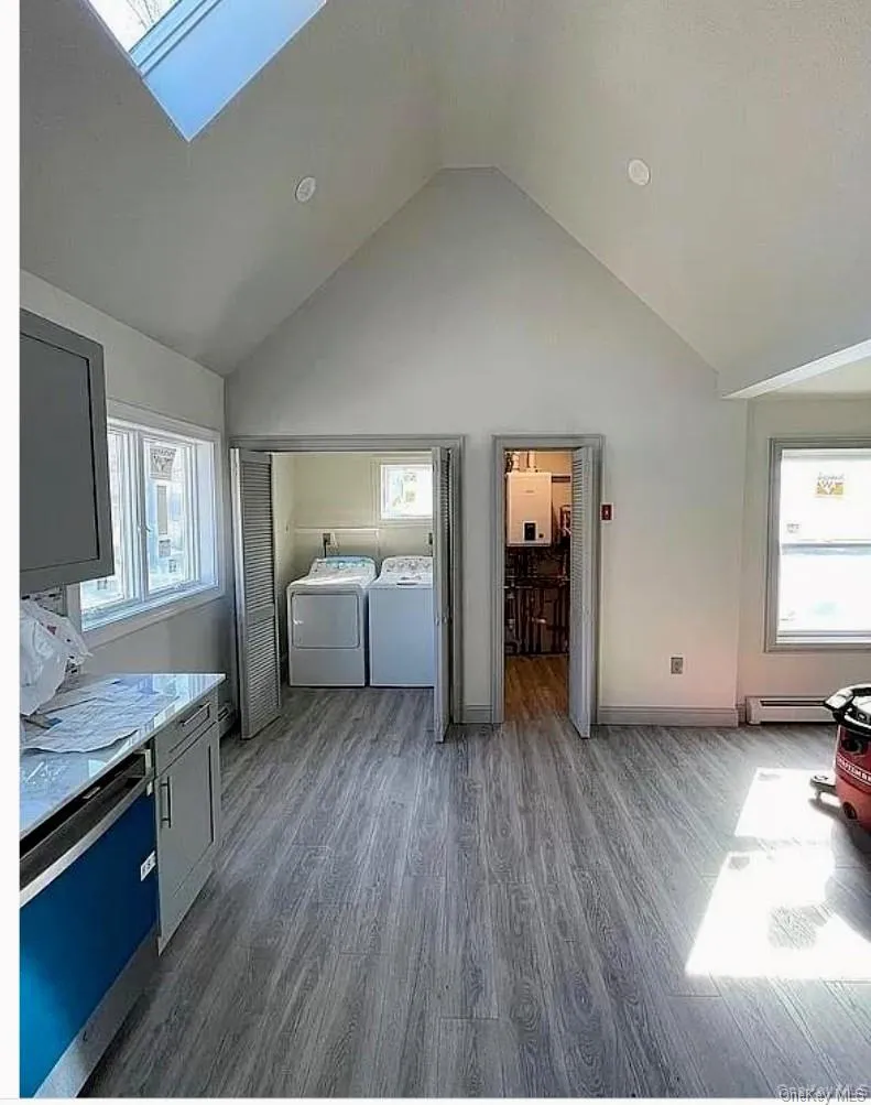 The large open kitchen with sky light and windows has the laundry space and utility room directly off of it. The large open kitchen with sky light and windows has the laundry space and utility room directly off of it.