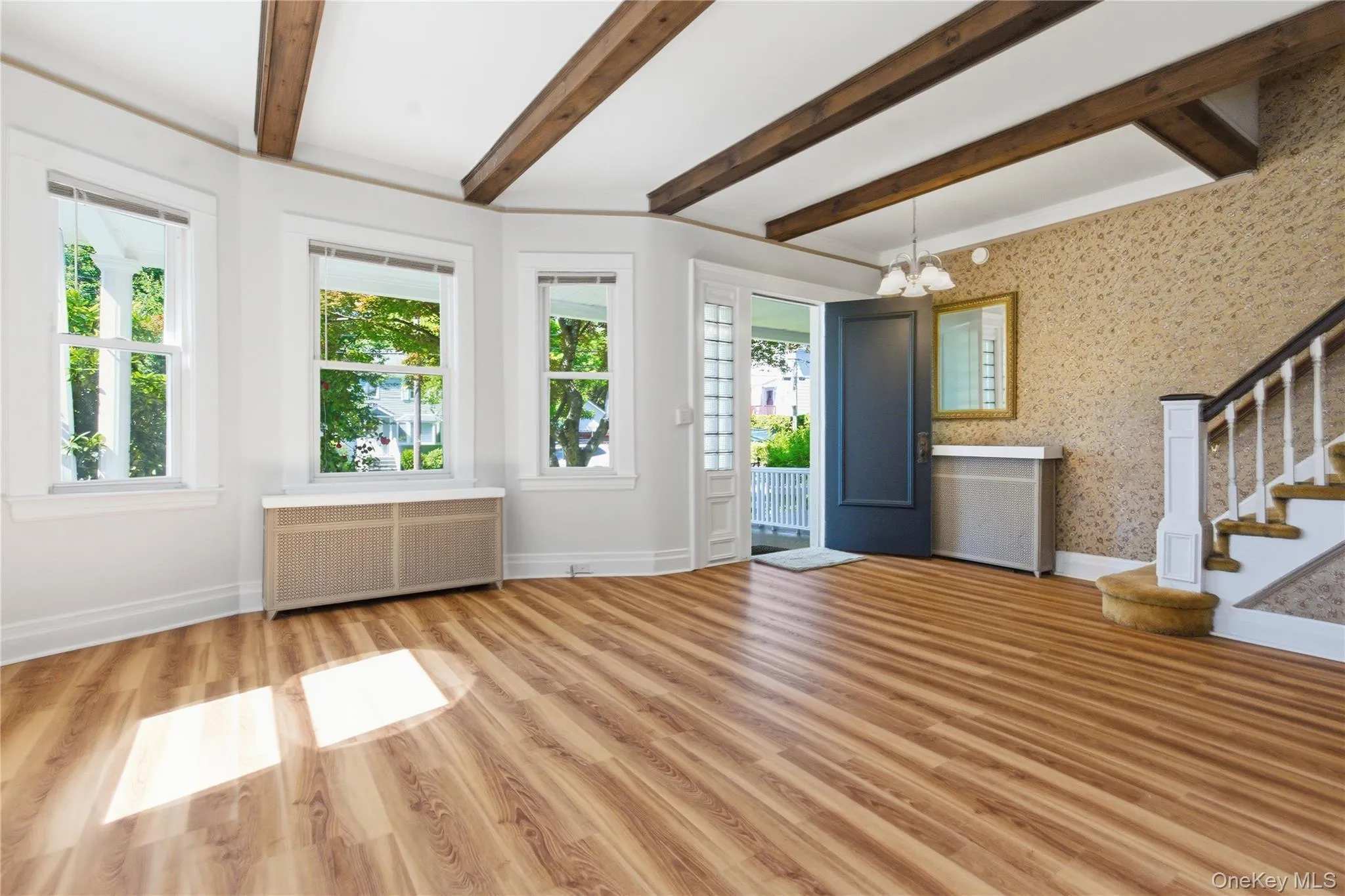 Warm and inviting gathering space showcasing timeless architectural details, hardwood flooring, and abundant sunlight. Warm and inviting gathering space showcasing timeless architectural details, hardwood flooring, and abundant sunlight.