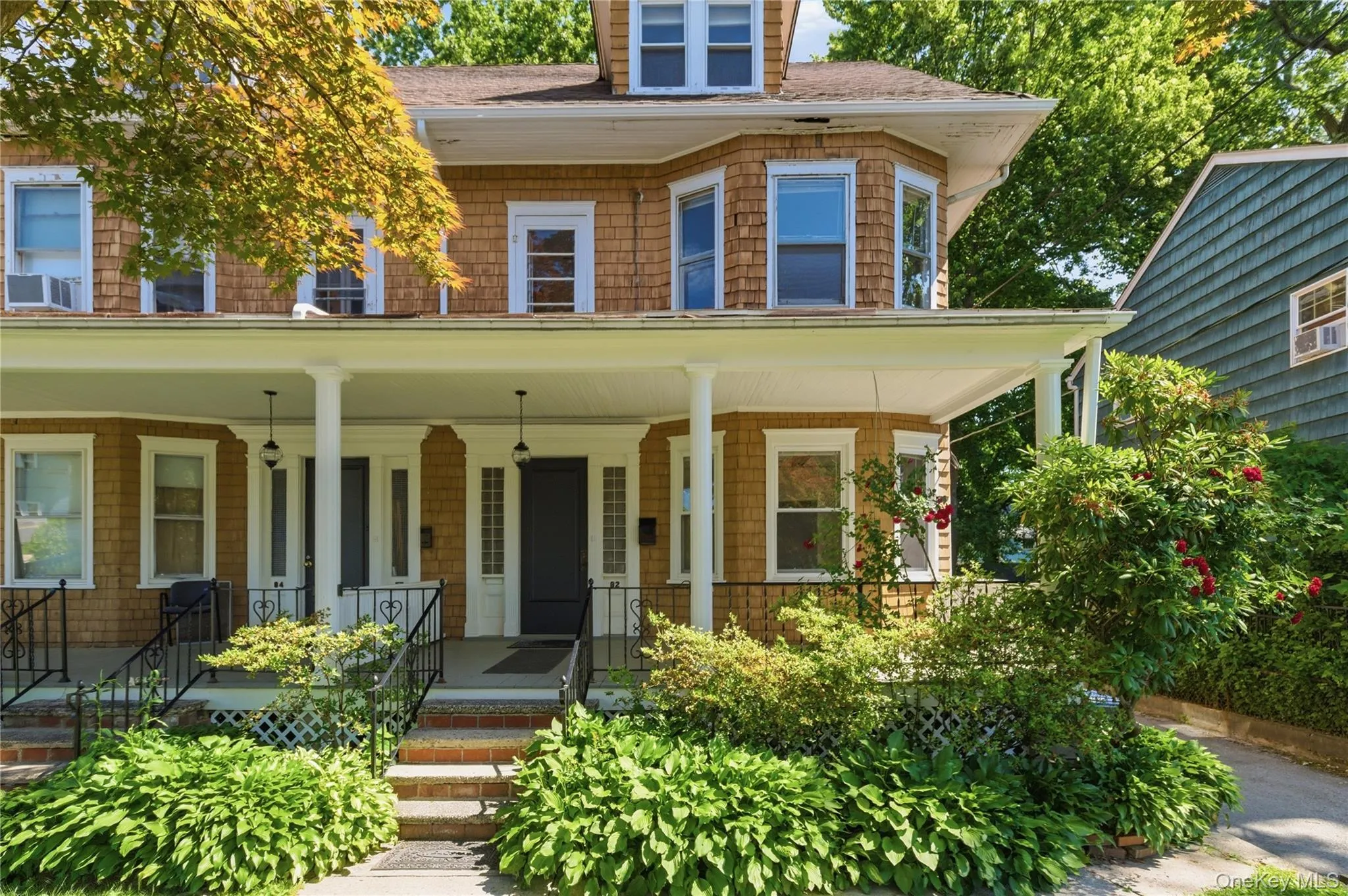 Classic curb appeal with a welcoming covered front porch, mature landscaping, and timeless architectural character. Classic curb appeal with a welcoming covered front porch, mature landscaping, and timeless architectural character.