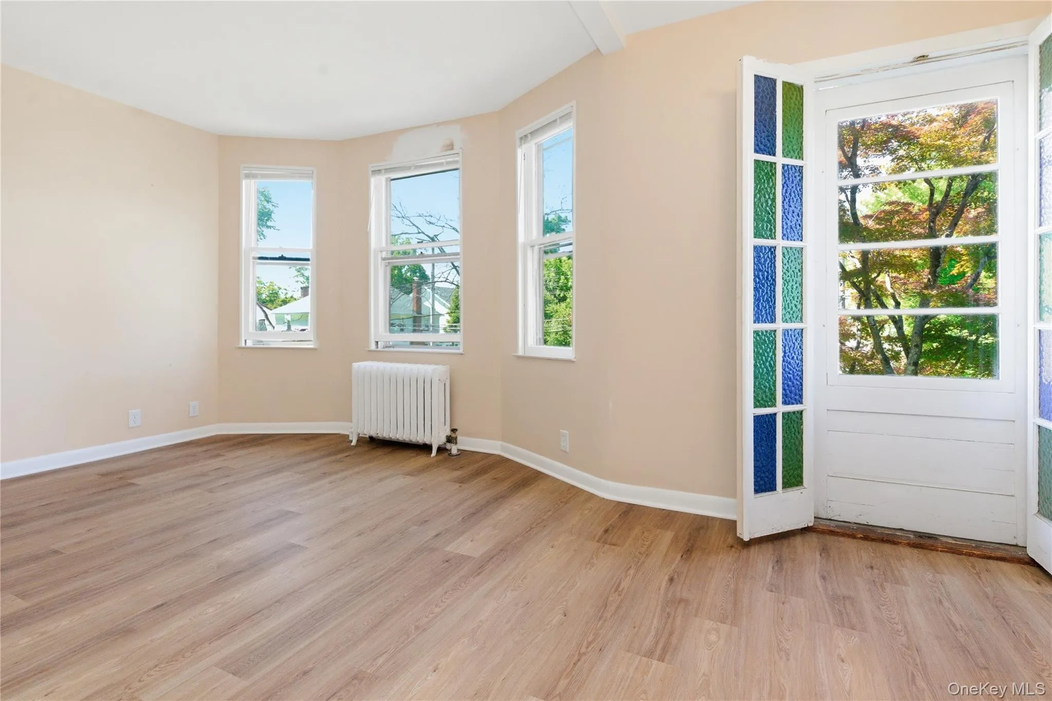 Generously sized bedroom with updated flooring, ample sunlight, and plenty of room for a king-sized bed and additional furnishings. Generously sized bedroom with updated flooring, ample sunlight, and plenty of room for a king-sized bed and additional furnishings.