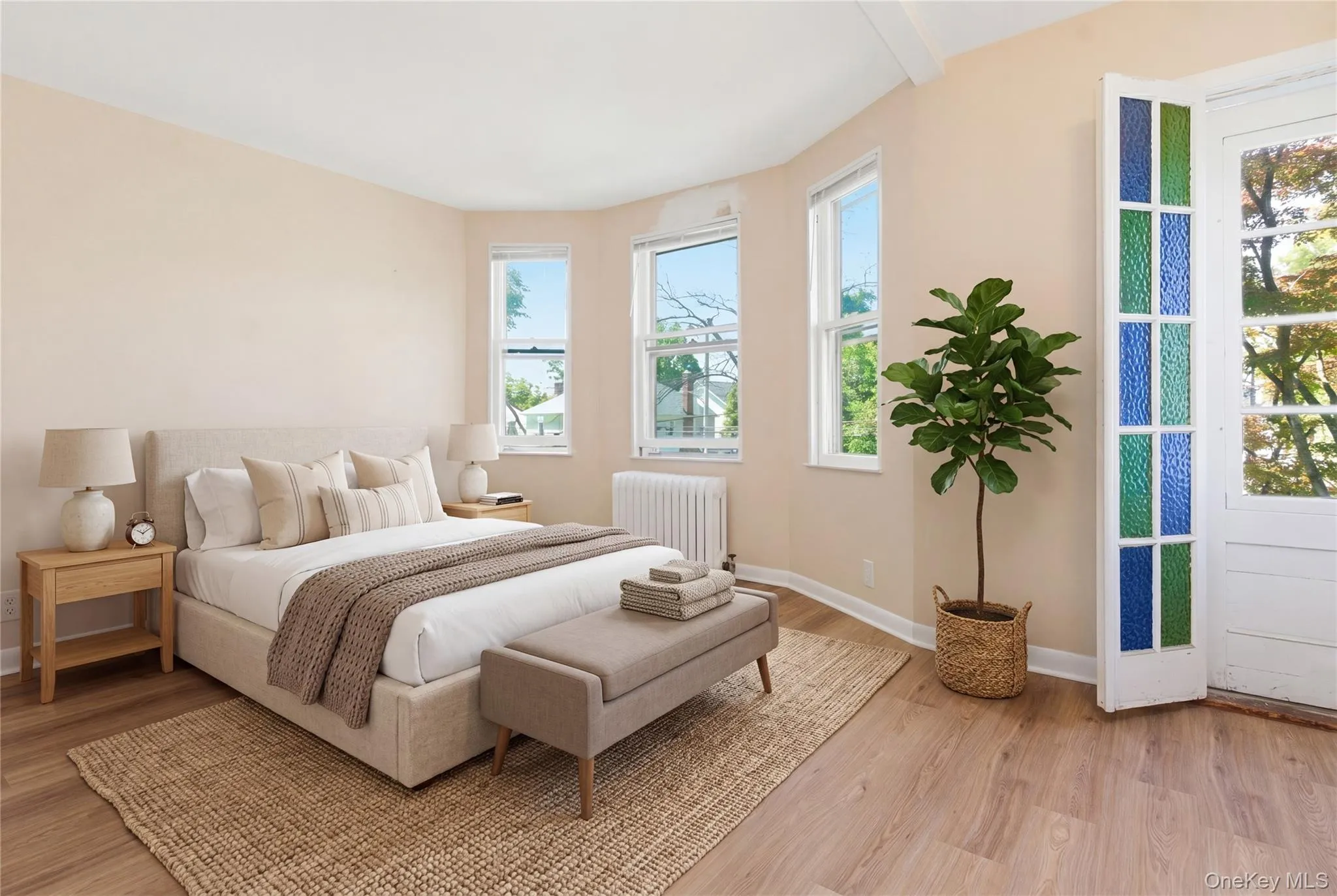 Generously sized bedroom with updated flooring, ample sunlight, and plenty of room for a king-sized bed and additional furnishings. Please note: picture has been staged. Generously sized bedroom with updated flooring, ample sunlight, and plenty of room for a king-sized bed and additional furnishings. Please note: picture has been staged.