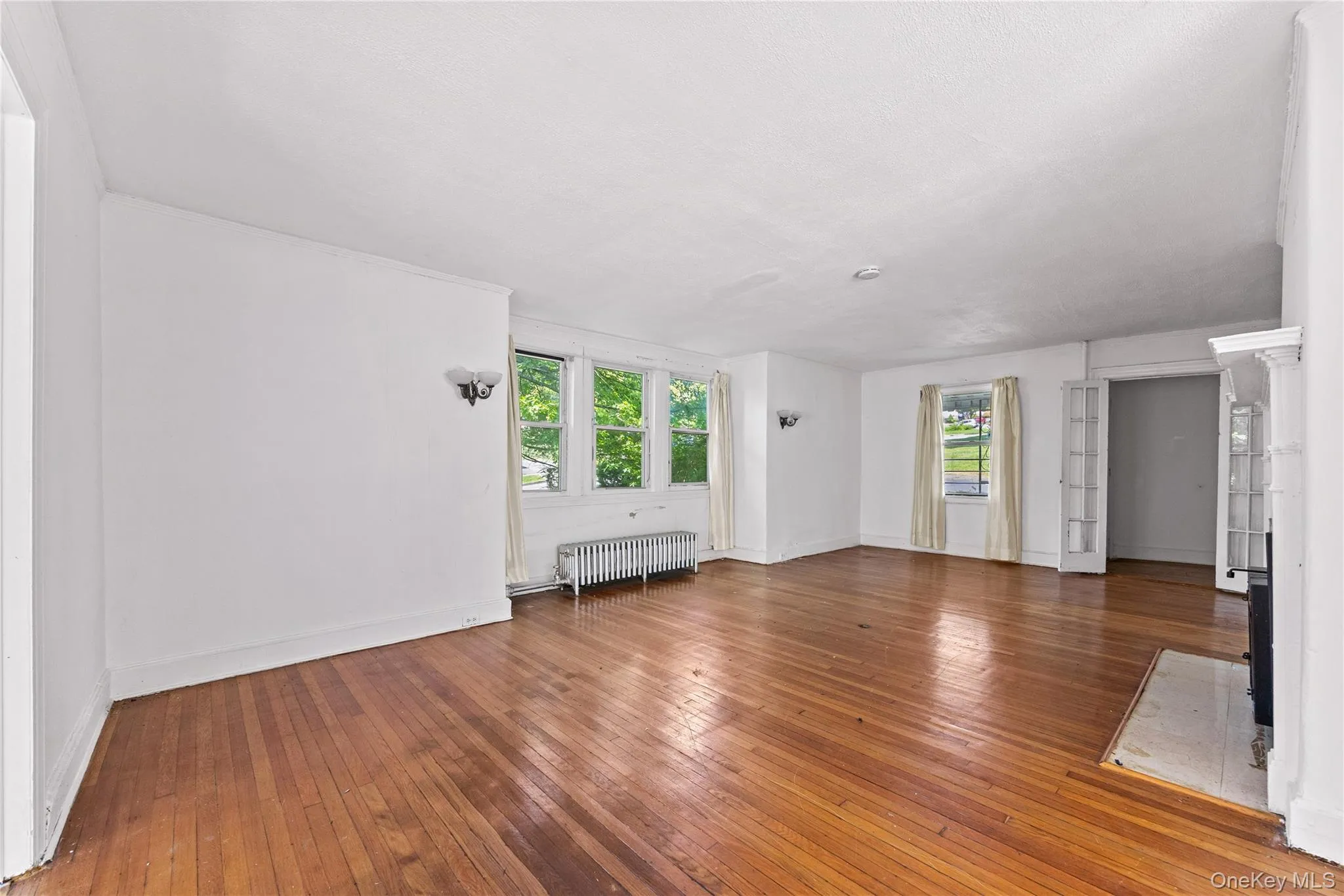 Living room with hardwood floors, great light and a fireplace. Living room with hardwood floors, great light and a fireplace.