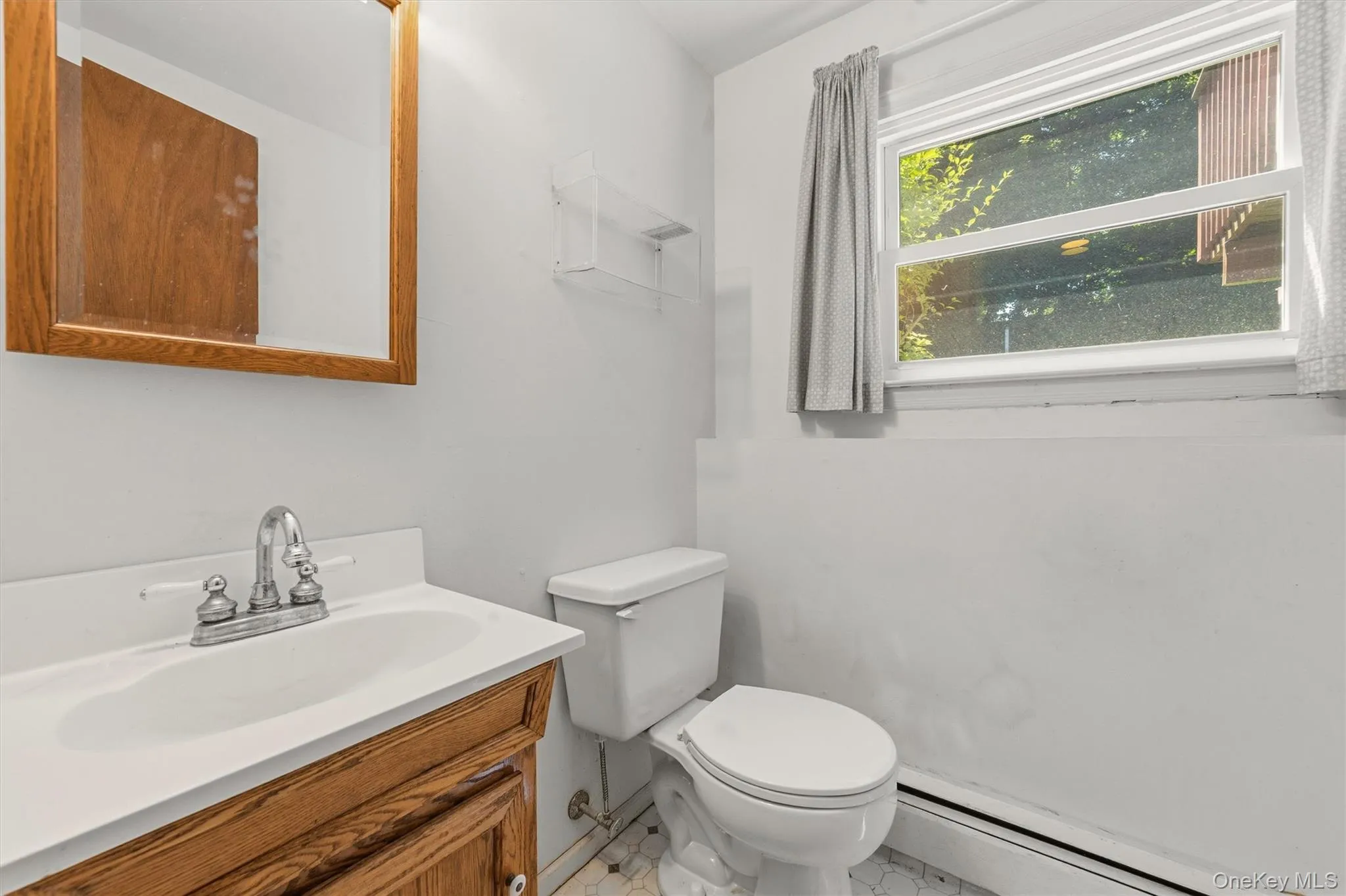 Lower level powder room with medicine cabinet and window. Lower level powder room with medicine cabinet and window.