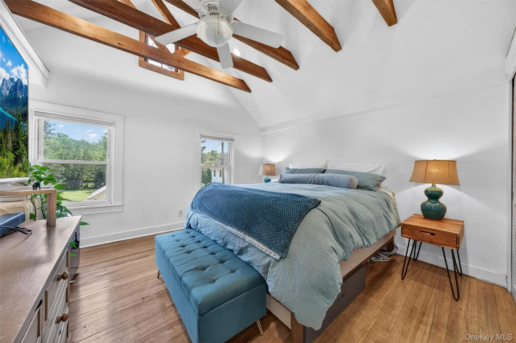 What a show stopper! The primary bedroom has exposed beams and high ceilings. What a show stopper! The primary bedroom has exposed beams and high ceilings.