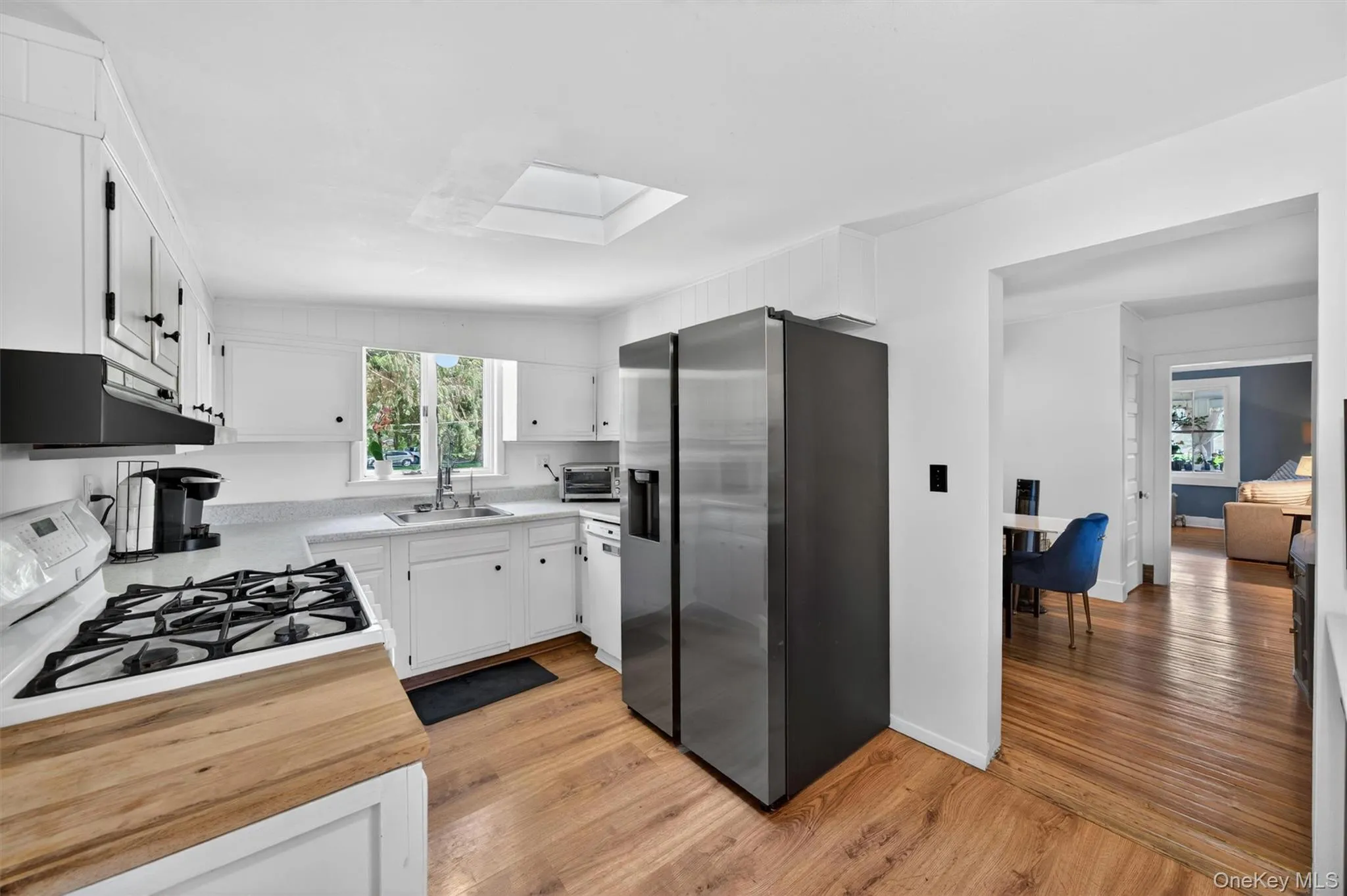 The kitchen window and skylight make the kitchen bright. The kitchen window and skylight make the kitchen bright.