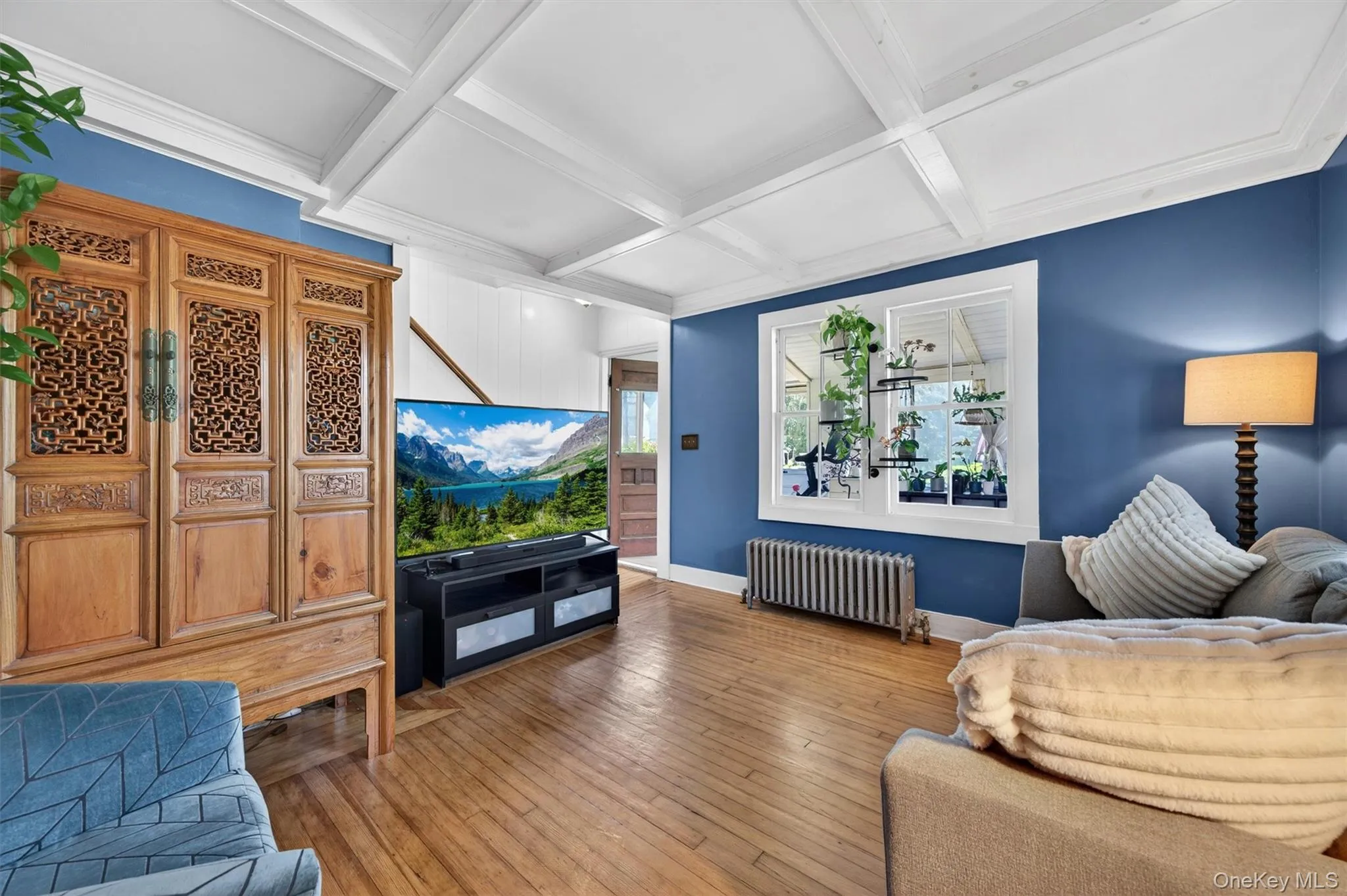 The living room offers hardwood floors and original beams. The living room offers hardwood floors and original beams.