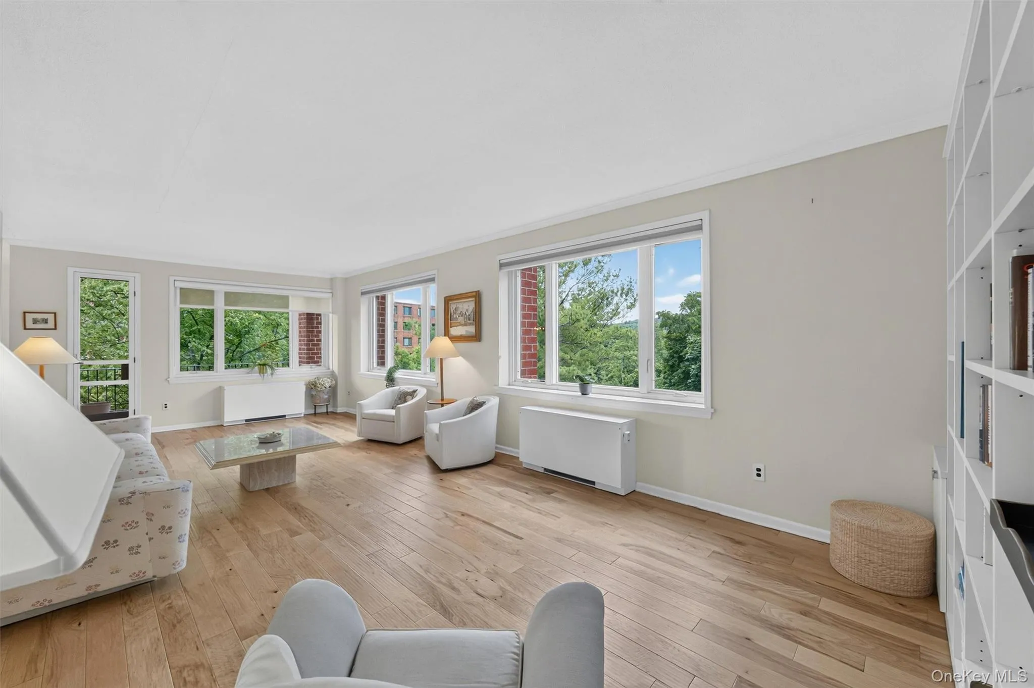 Open, light and airy living room with beautiful wood floors and oversized windows. Open, light and airy living room with beautiful wood floors and oversized windows.