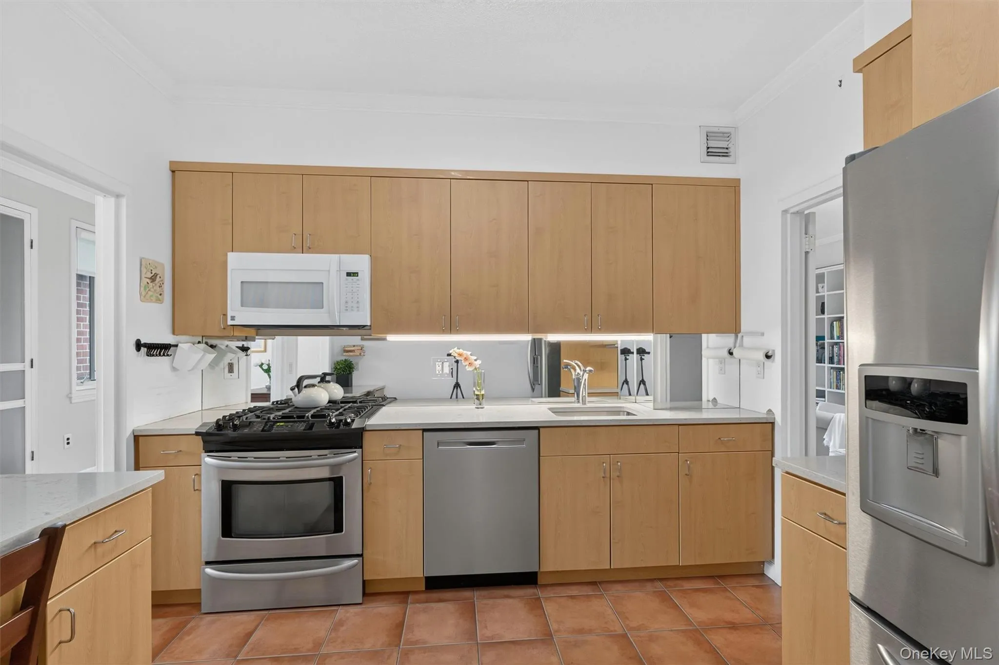Wood cabinets and terra cotta tiles add warm, soothing tones every chef appreciates, plus stainless steel appliances. Wood cabinets and terra cotta tiles add warm, soothing tones every chef appreciates, plus stainless steel appliances.