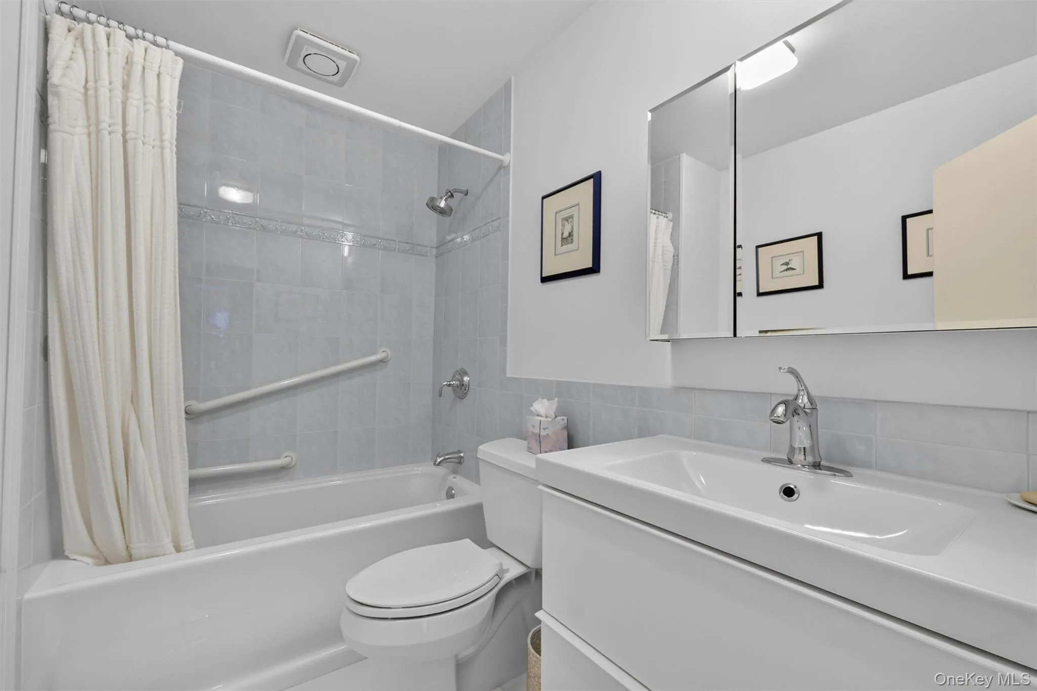 Renovated hall bath with shower/tub and grab bar. Renovated hall bath with shower/tub and grab bar.