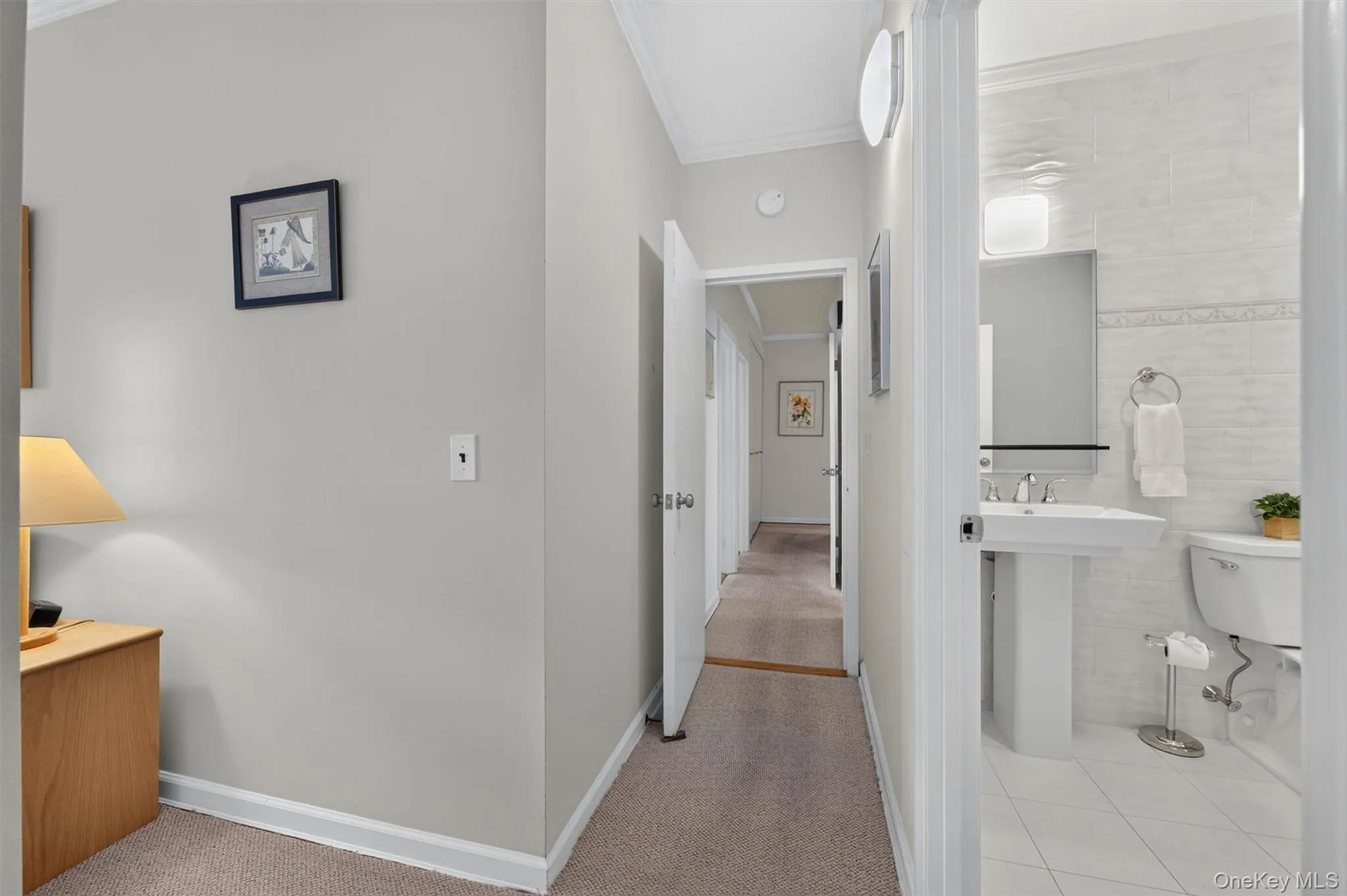 Primary ensuite hallway connects to the common hallway. Primary ensuite hallway connects to the common hallway.