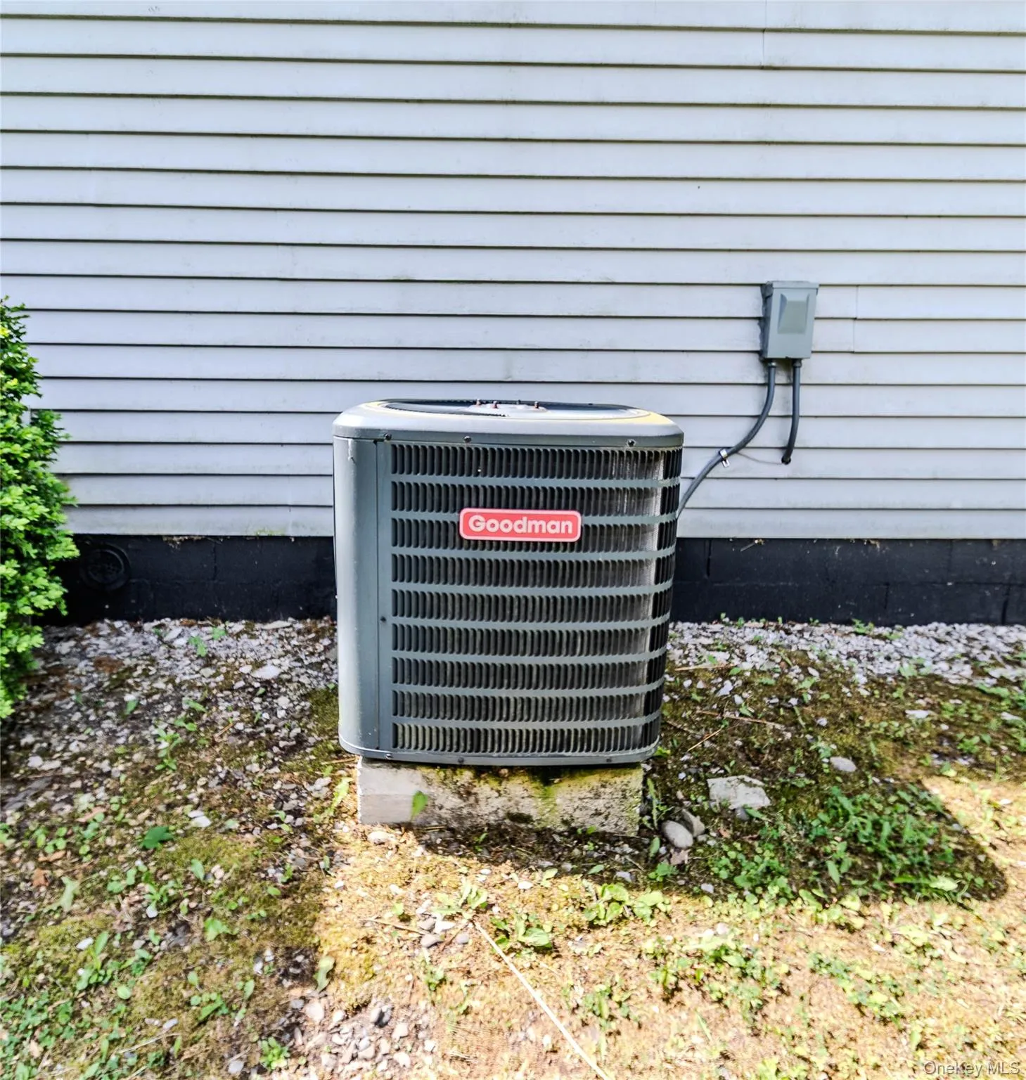 Goodman air conditioning unit on a concrete pad Goodman air conditioning unit on a concrete pad