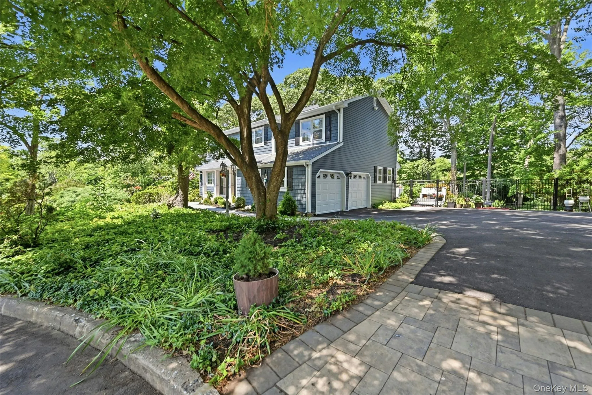 Driveway with paver apron, side of home, garage doors Driveway with paver apron, side of home, garage doors