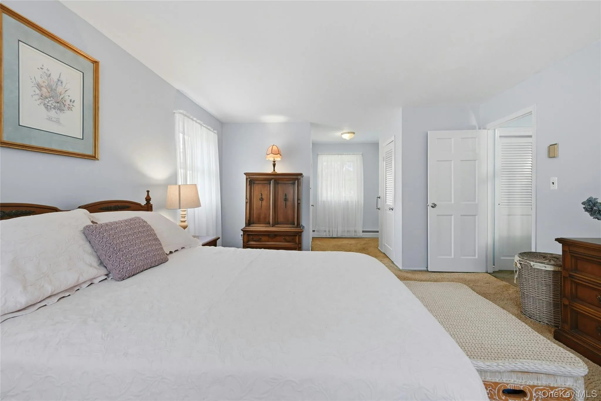 Primary bedroom with walk in closet and en-suite bathroom Primary bedroom with walk in closet and en-suite bathroom