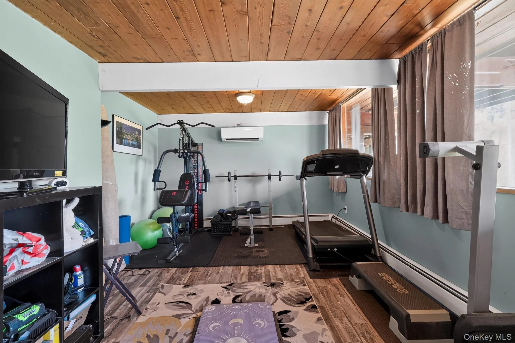 Recreation room featuring wood-finish ceiling, light blue walls, and multiple windows Recreation room featuring wood-finish ceiling, light blue walls, and multiple windows