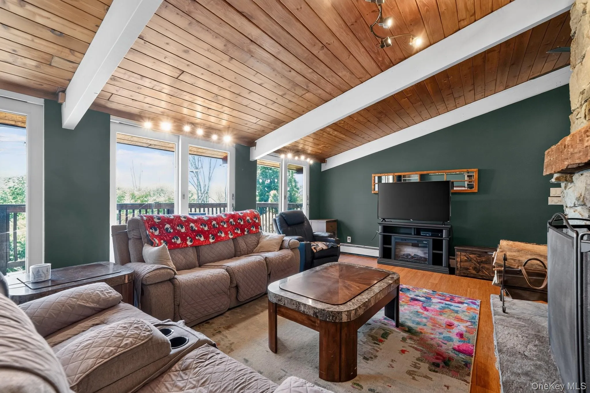 Vaulted wood-paneled ceiling with exposed white beams Vaulted wood-paneled ceiling with exposed white beams
