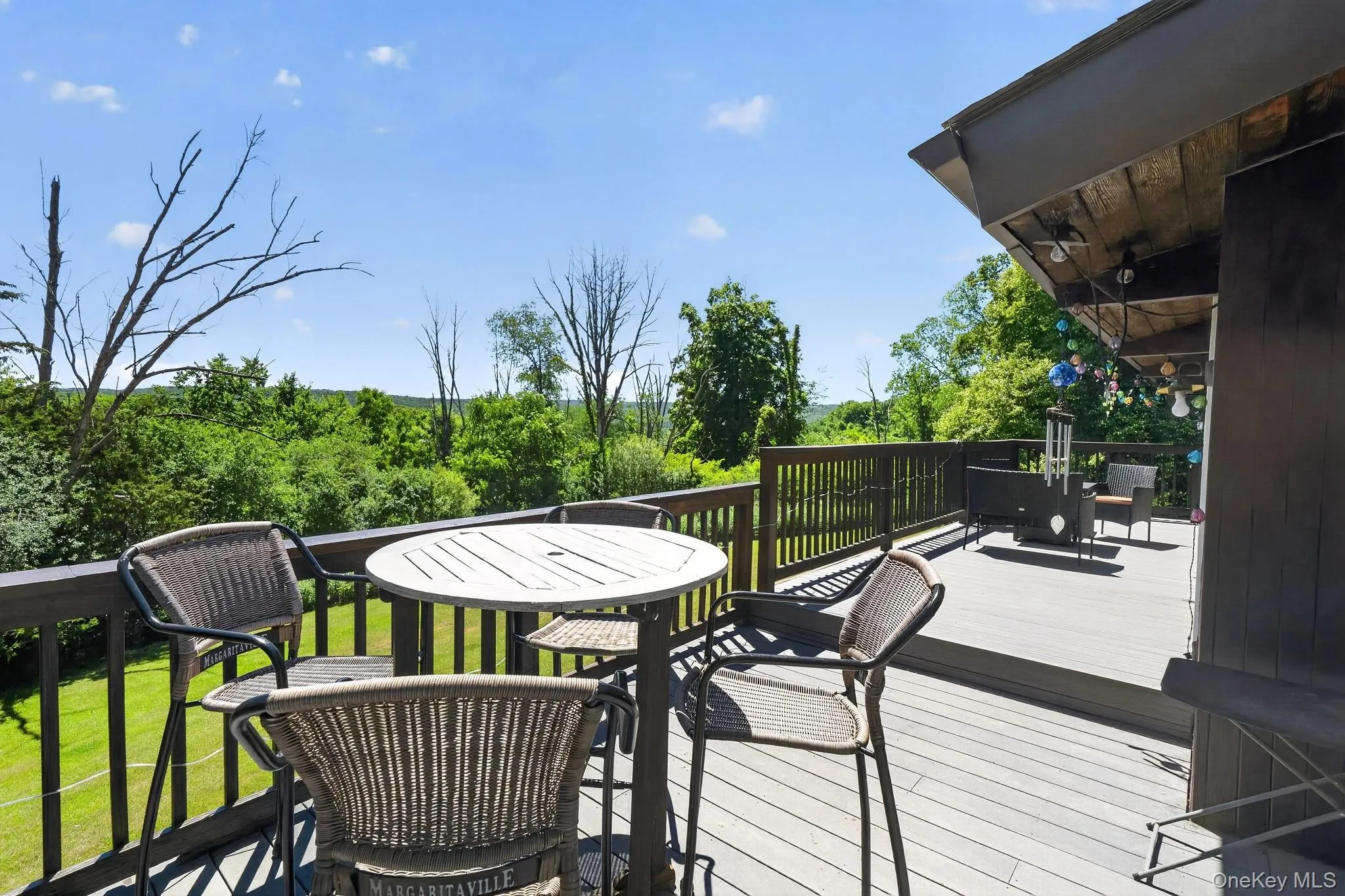Expansive multi-level deck featuring composite decking and dark wood railings Expansive multi-level deck featuring composite decking and dark wood railings